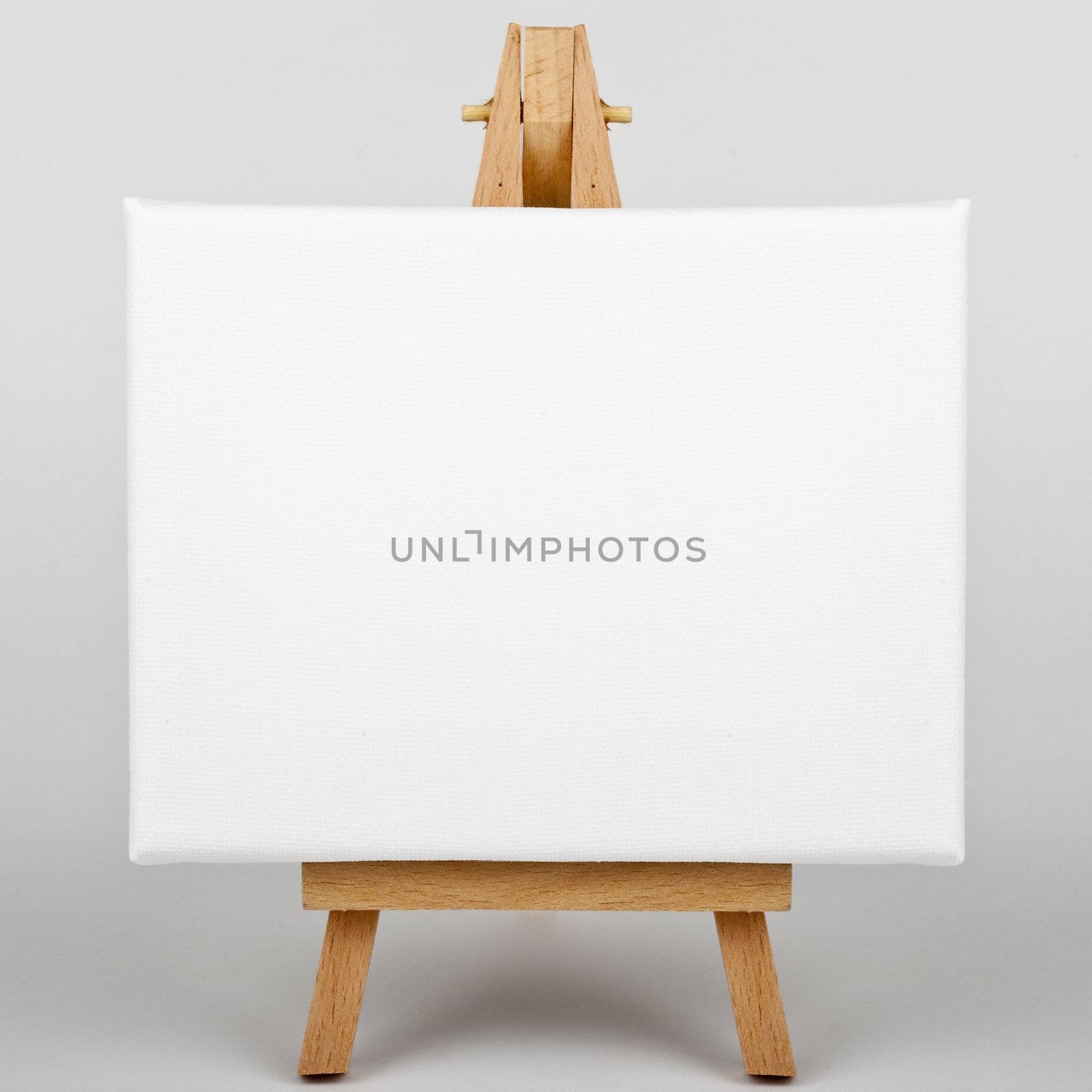 A white canvas on an easel.