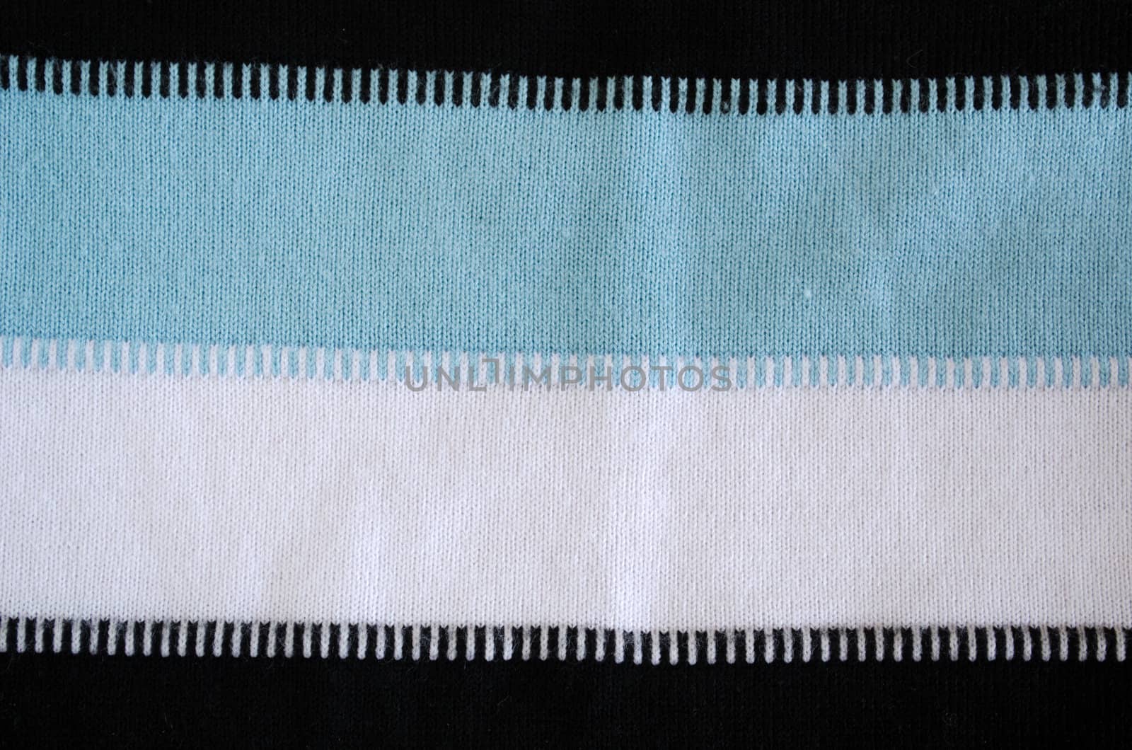 background of pullover ornament pattern. white black blue horizontal colors texture lines closeup.