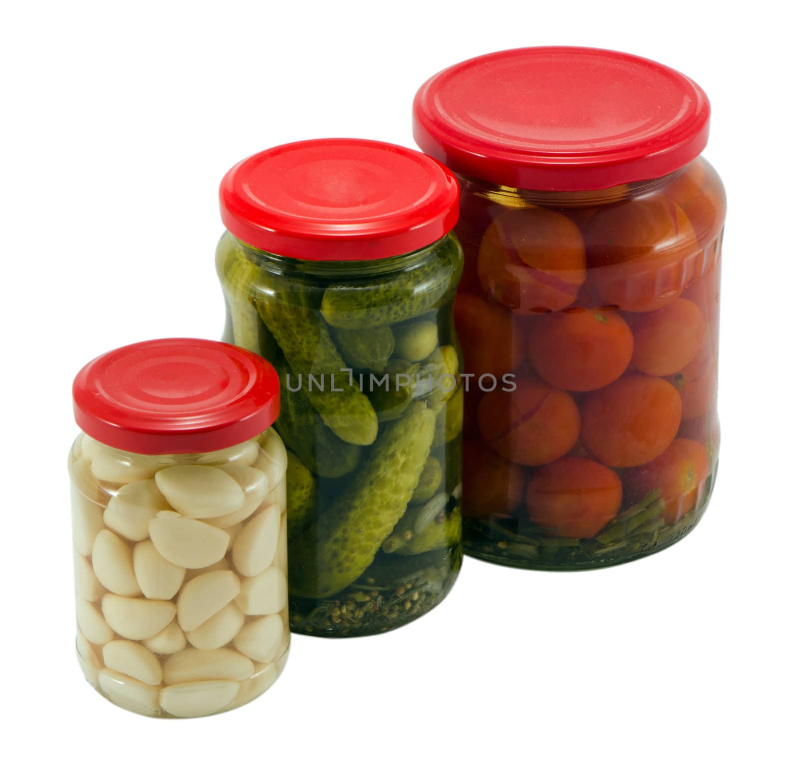 garlic cucumber tomatoes canned preserved in glass pots jars isolated on white background ecological natural food resource for winter