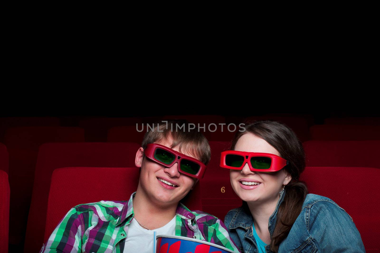 couple in a movie theater, watching a 3D movie