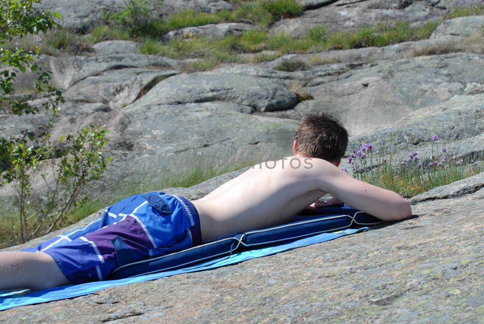 Teenage boy sunbathing