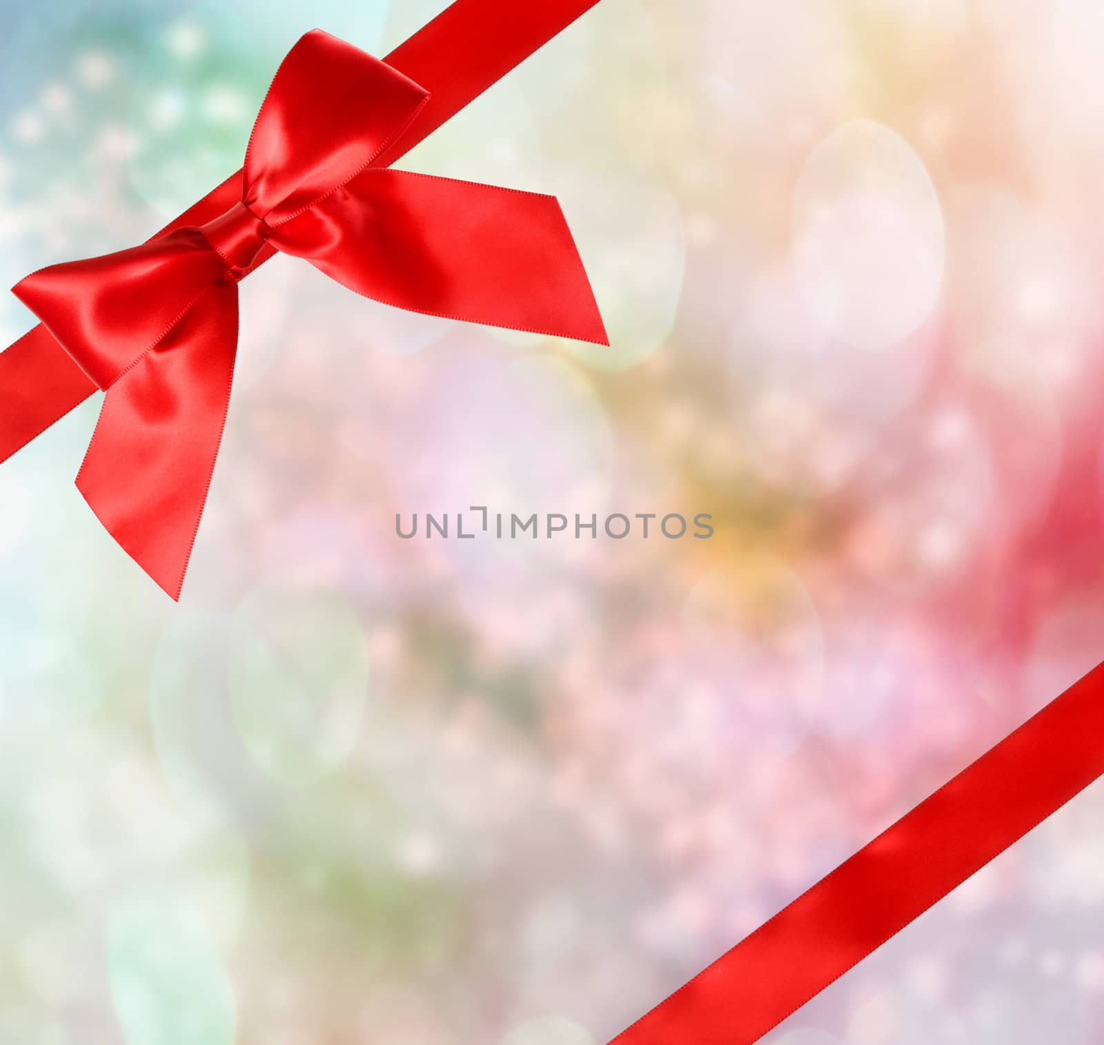 Red Bow and Ribbon with Pastel Bokeh Lights Background 
