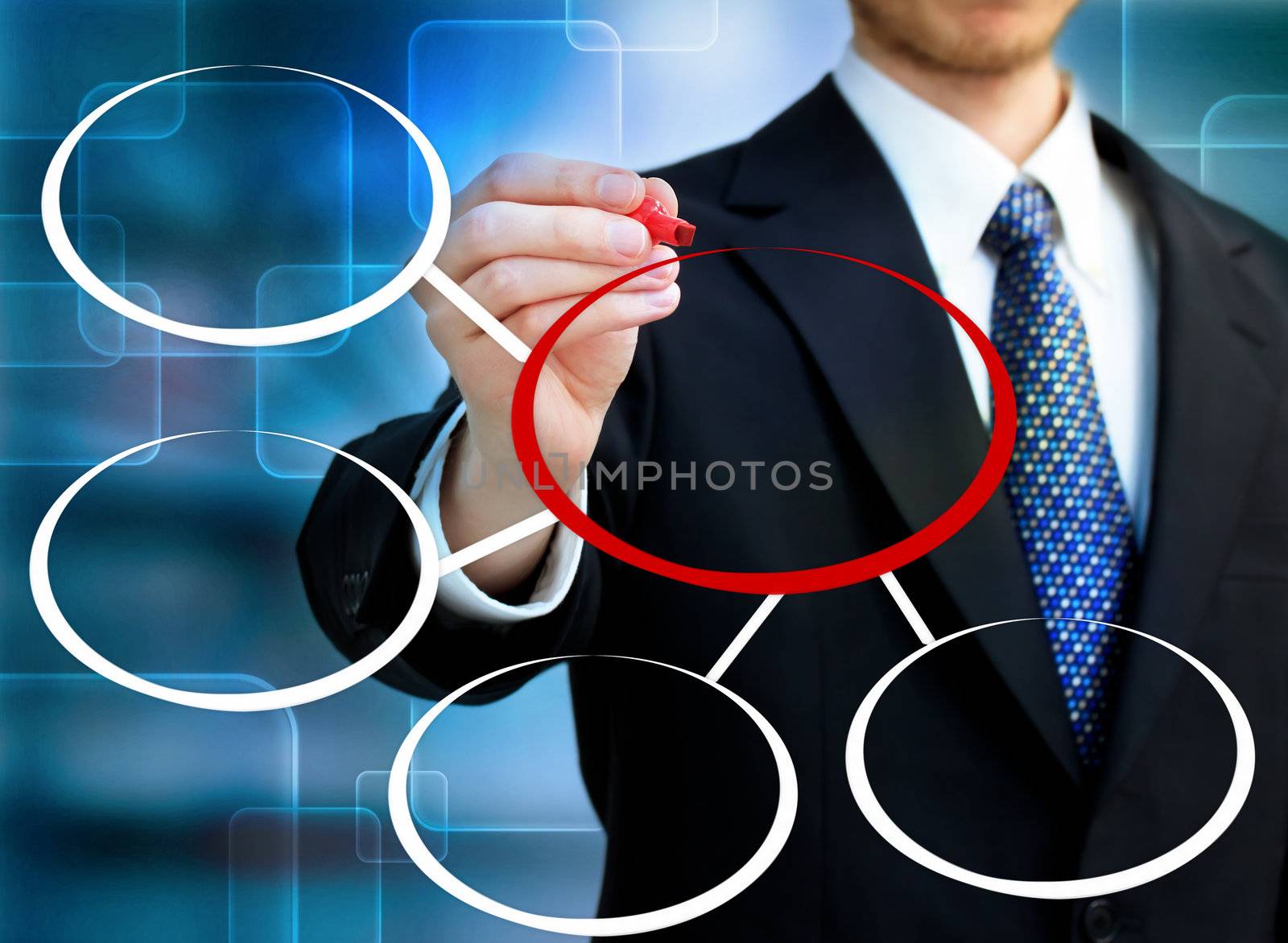 Businessman drawing circles in blue technology background