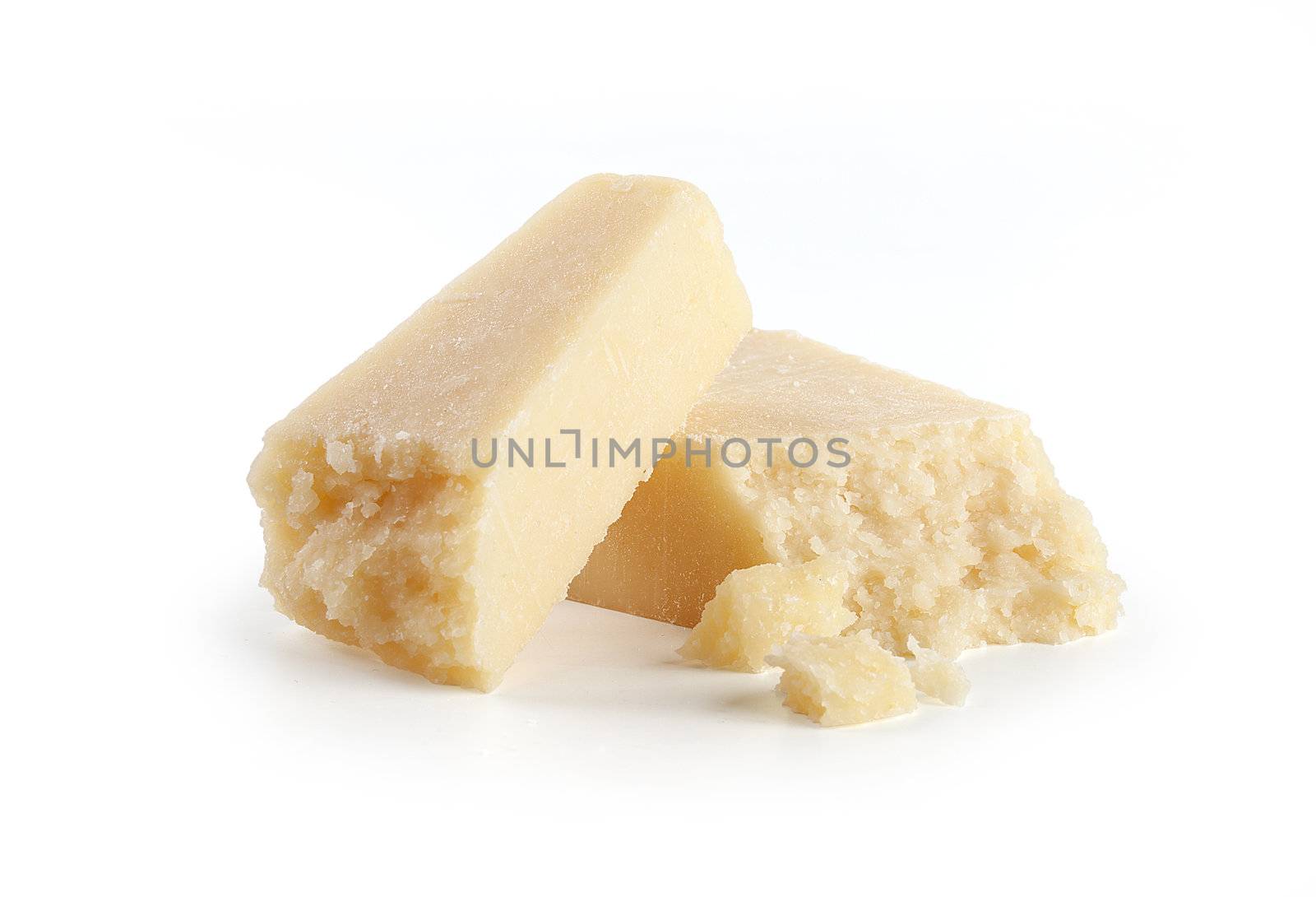 Two pieces of hard cheese on the white background