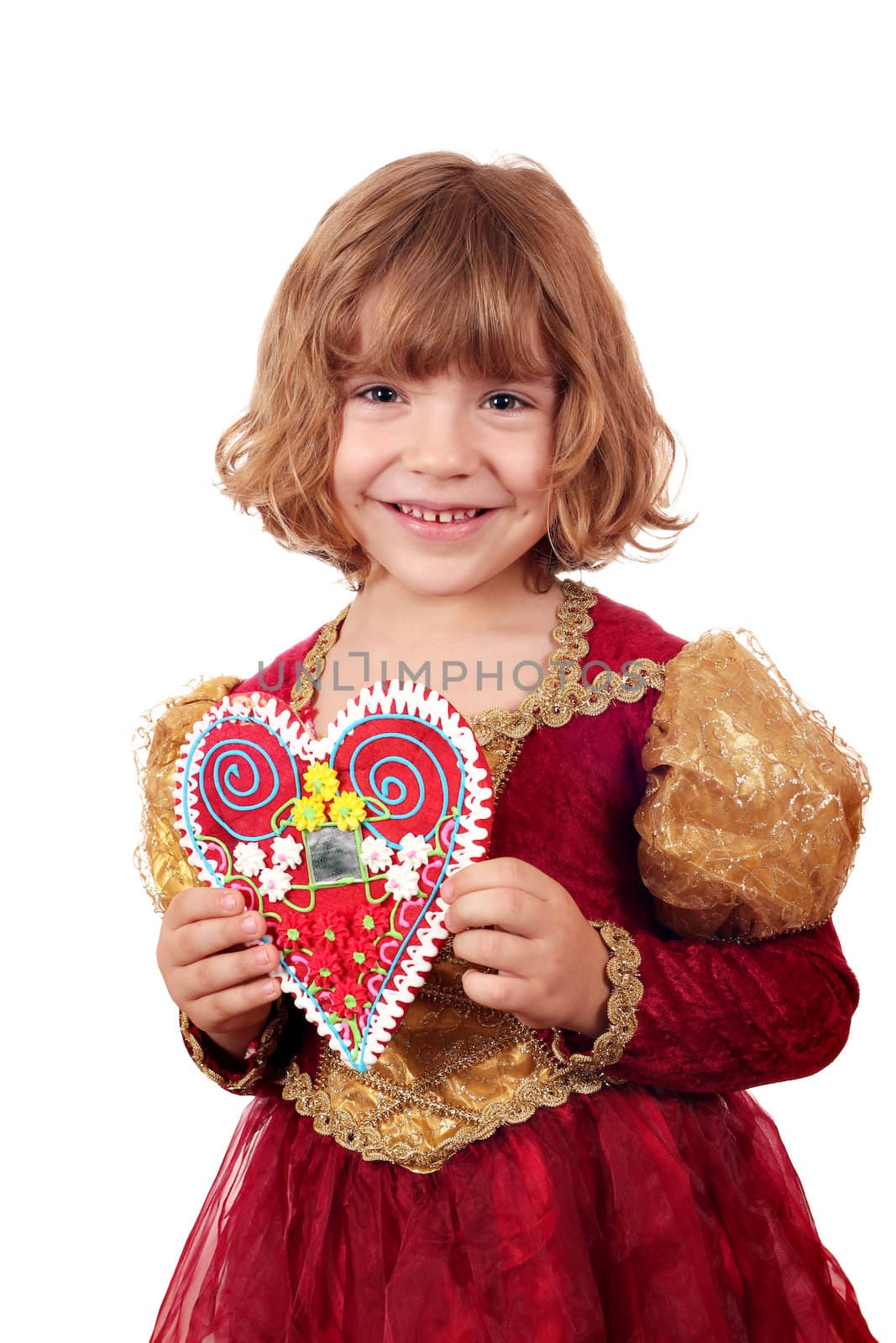 beautiful little girl holding gingerbread heart