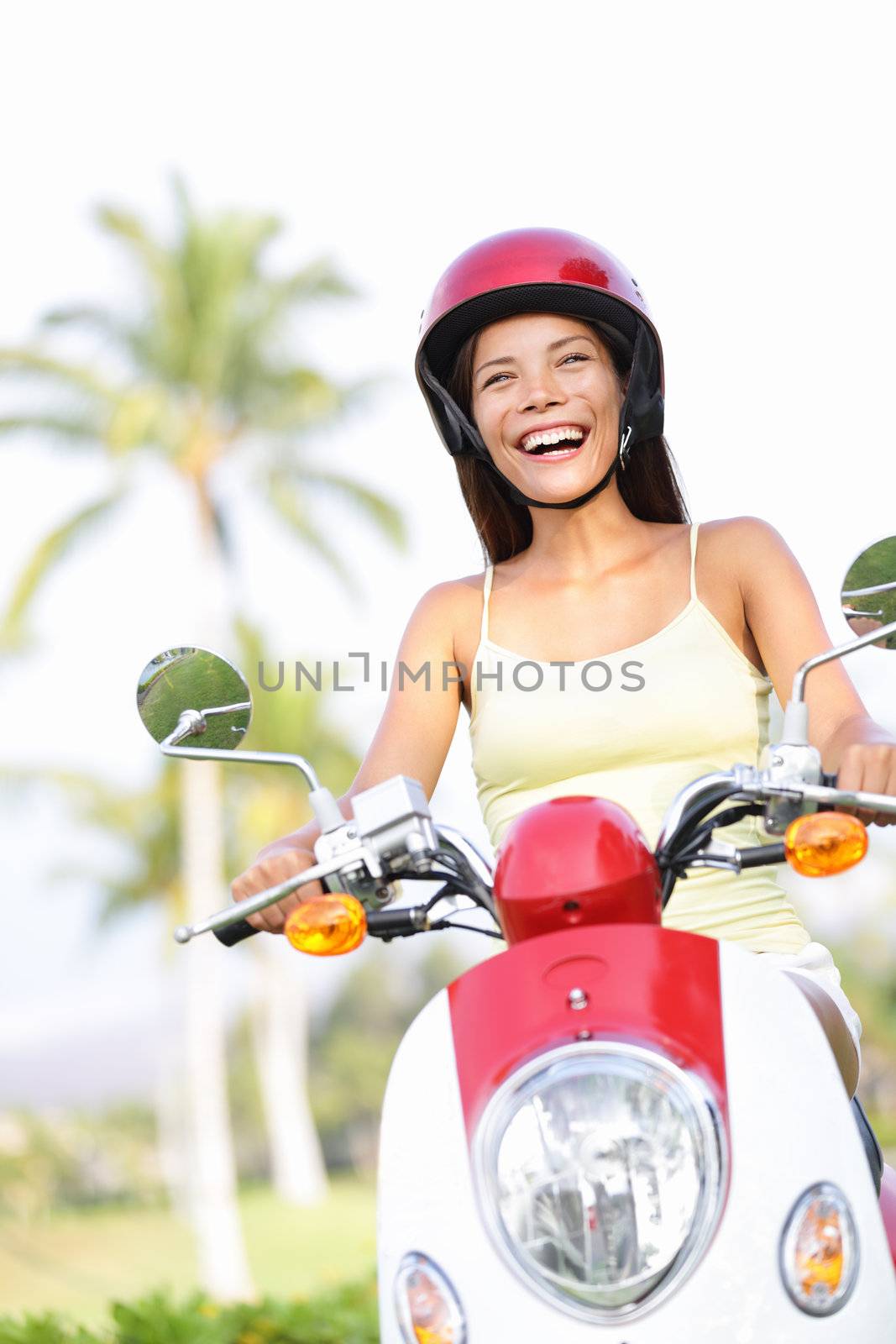 Free woman riding scooter happy by Maridav