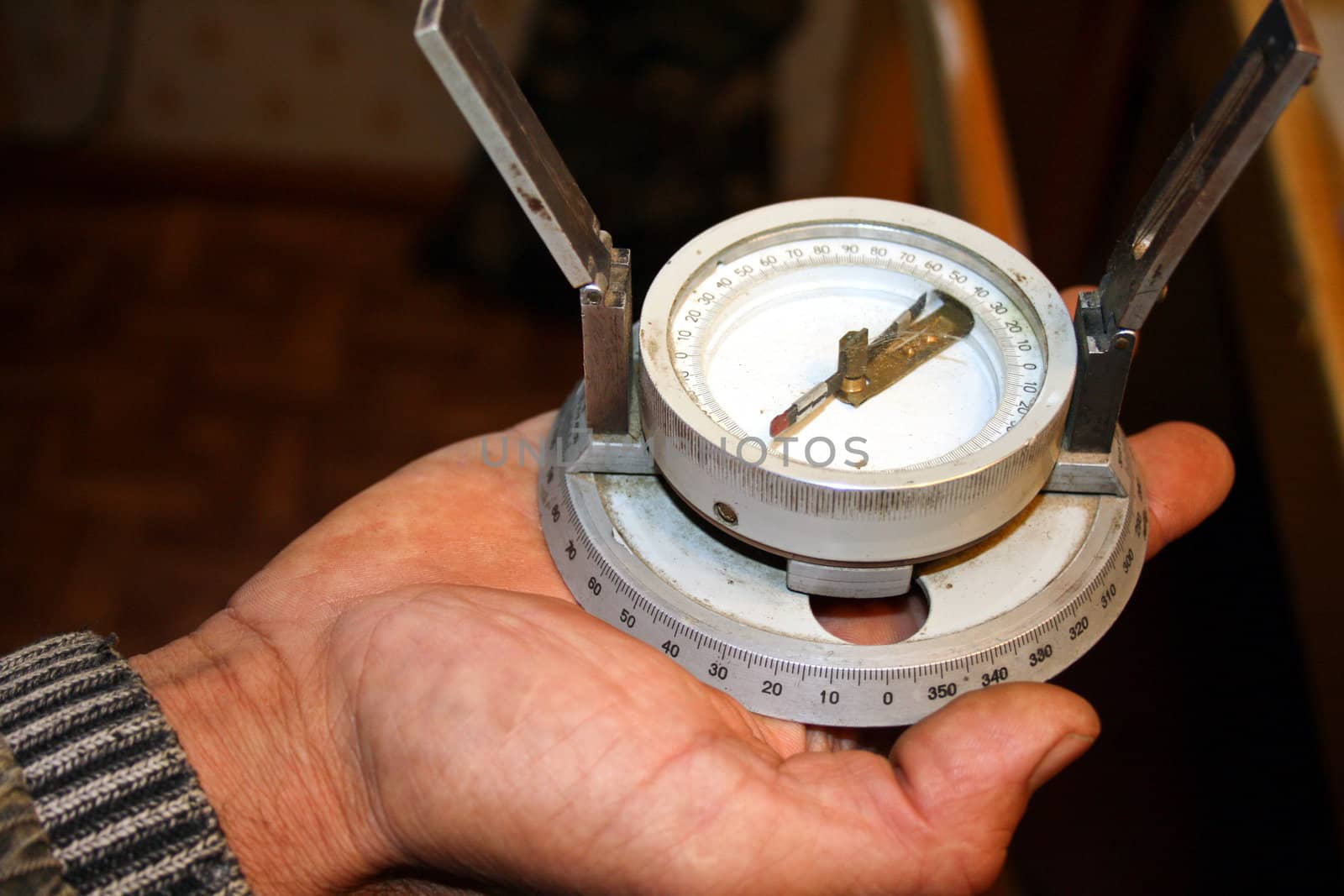 Professional magnetic compass in a hand of the expert