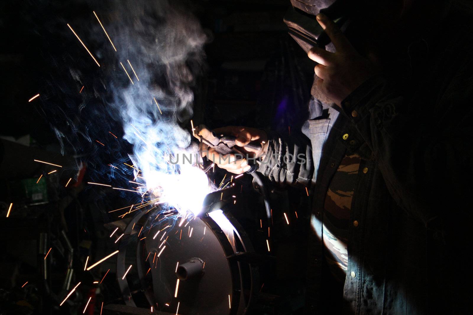 The expert works with electric welding of metal