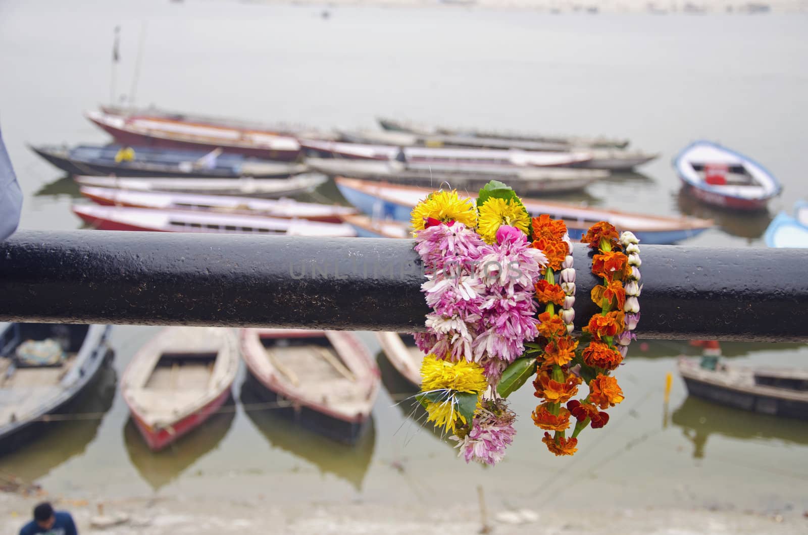 flowers and boats in Varanasi near sacred Ganges river, India