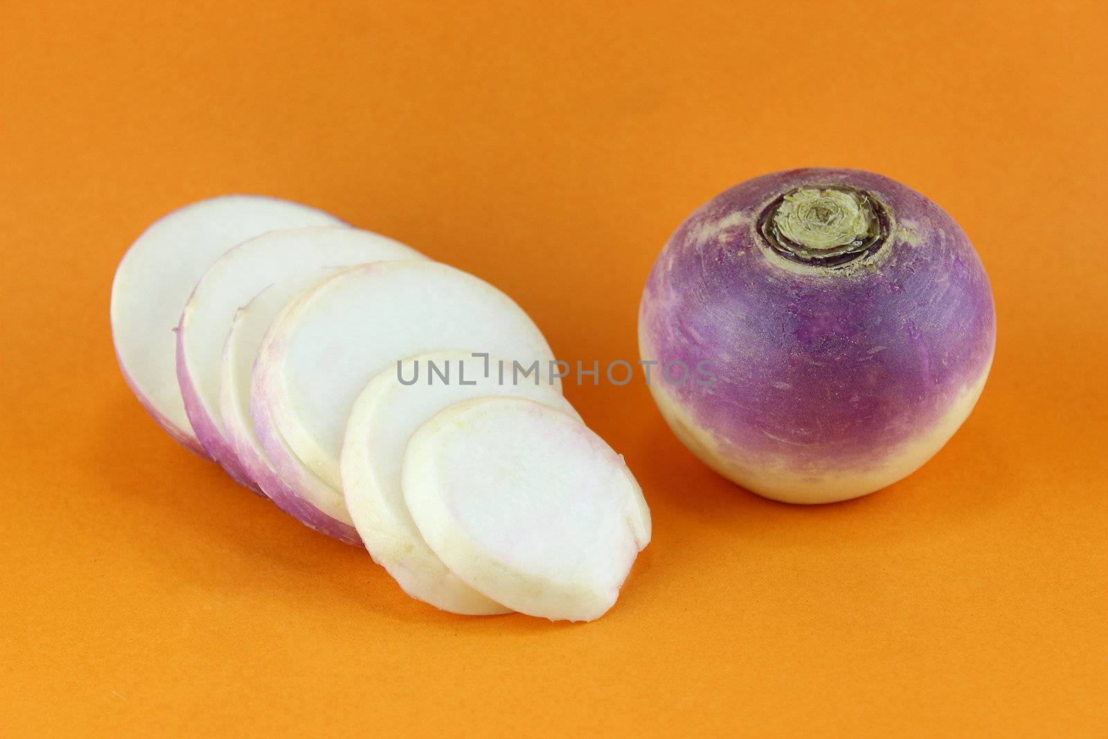 purple headed turnips with slices on orange background