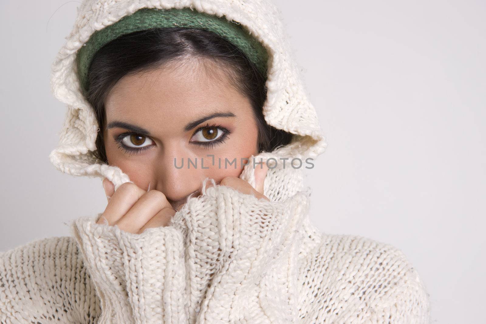 Attractive Woman Covering Half Her Face with Sweater by ChrisBoswell