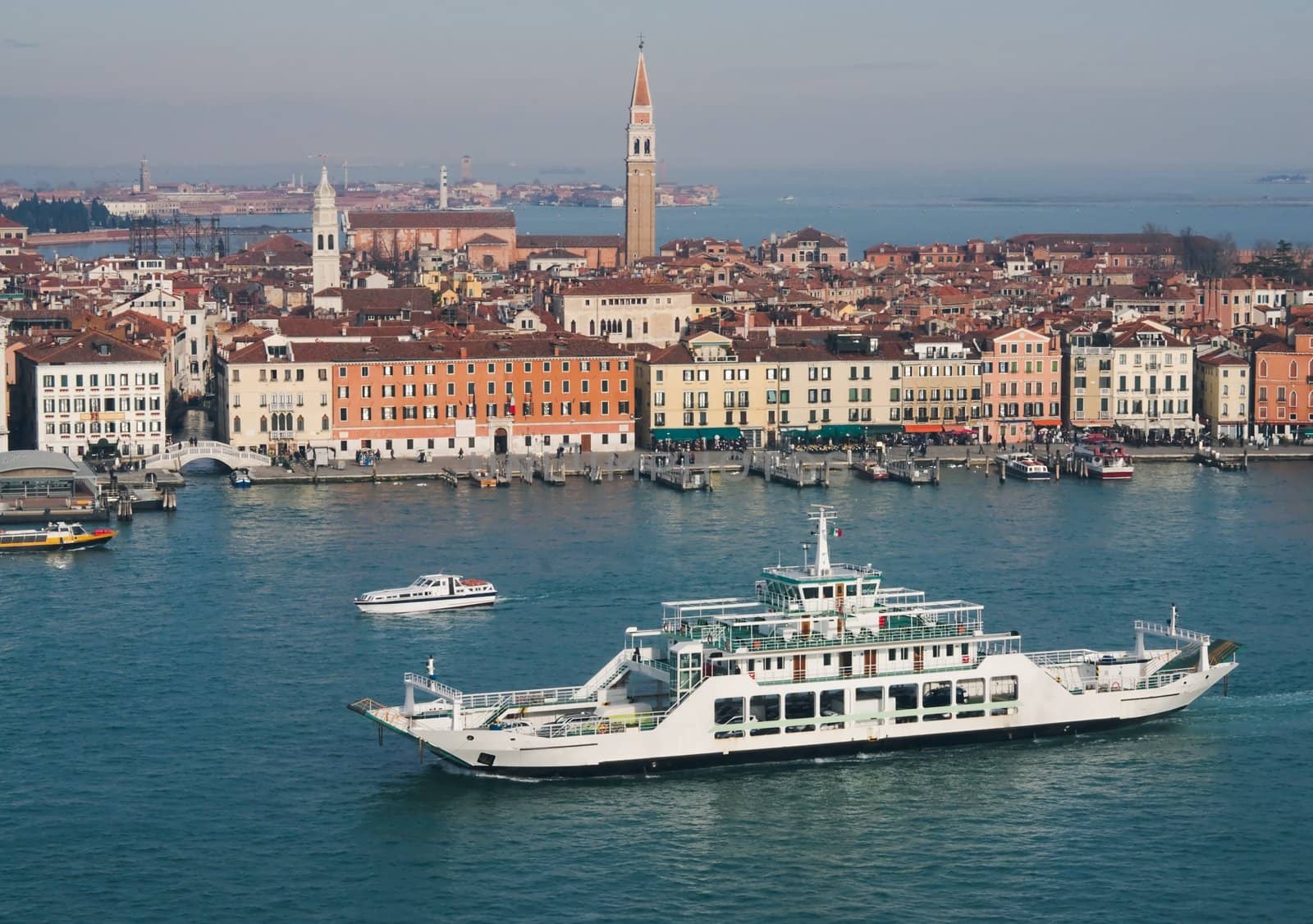 View of Venice in winter sunny day with a ferry boat in the foreground