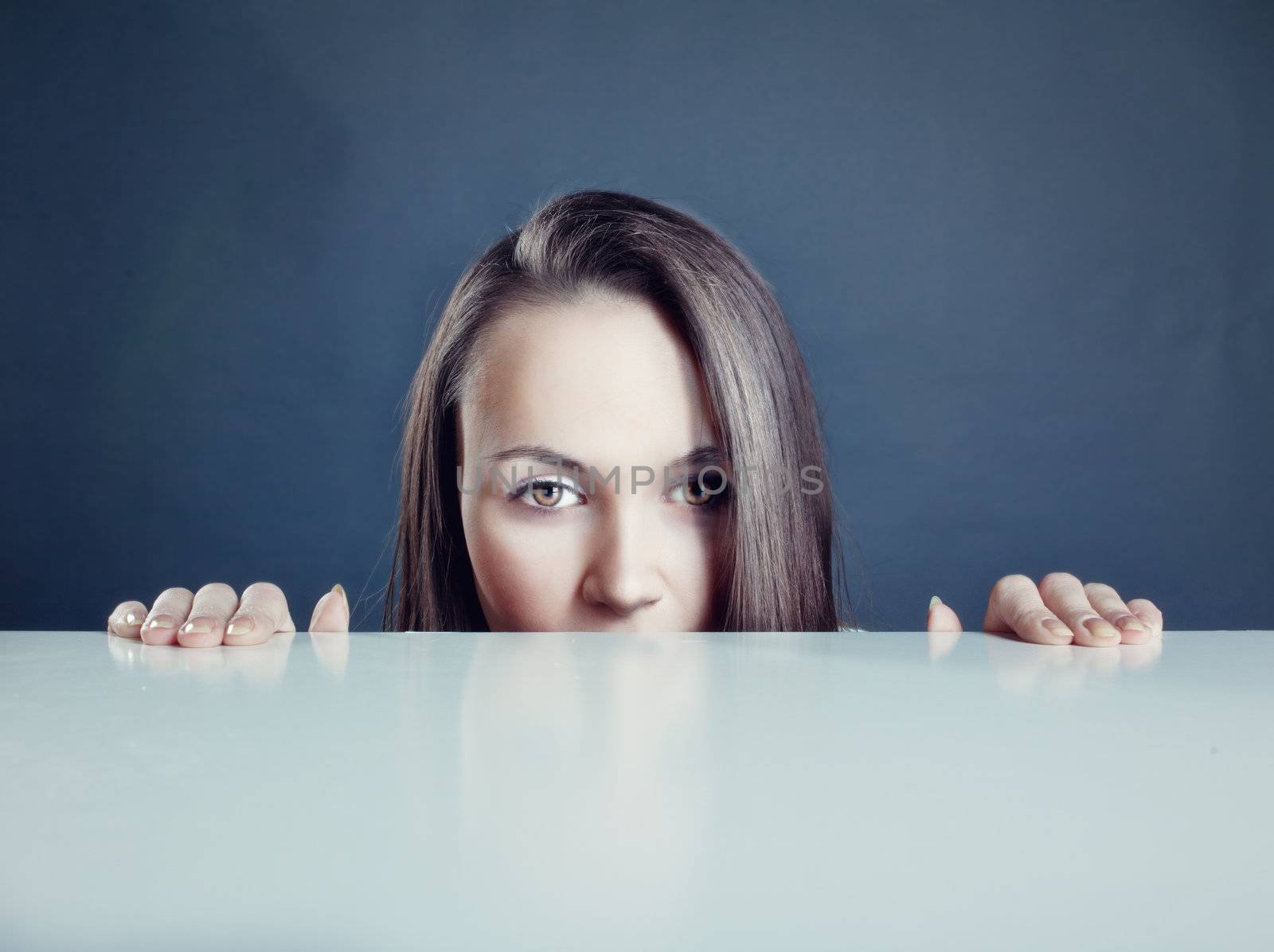 beautiful woman looking over a table 