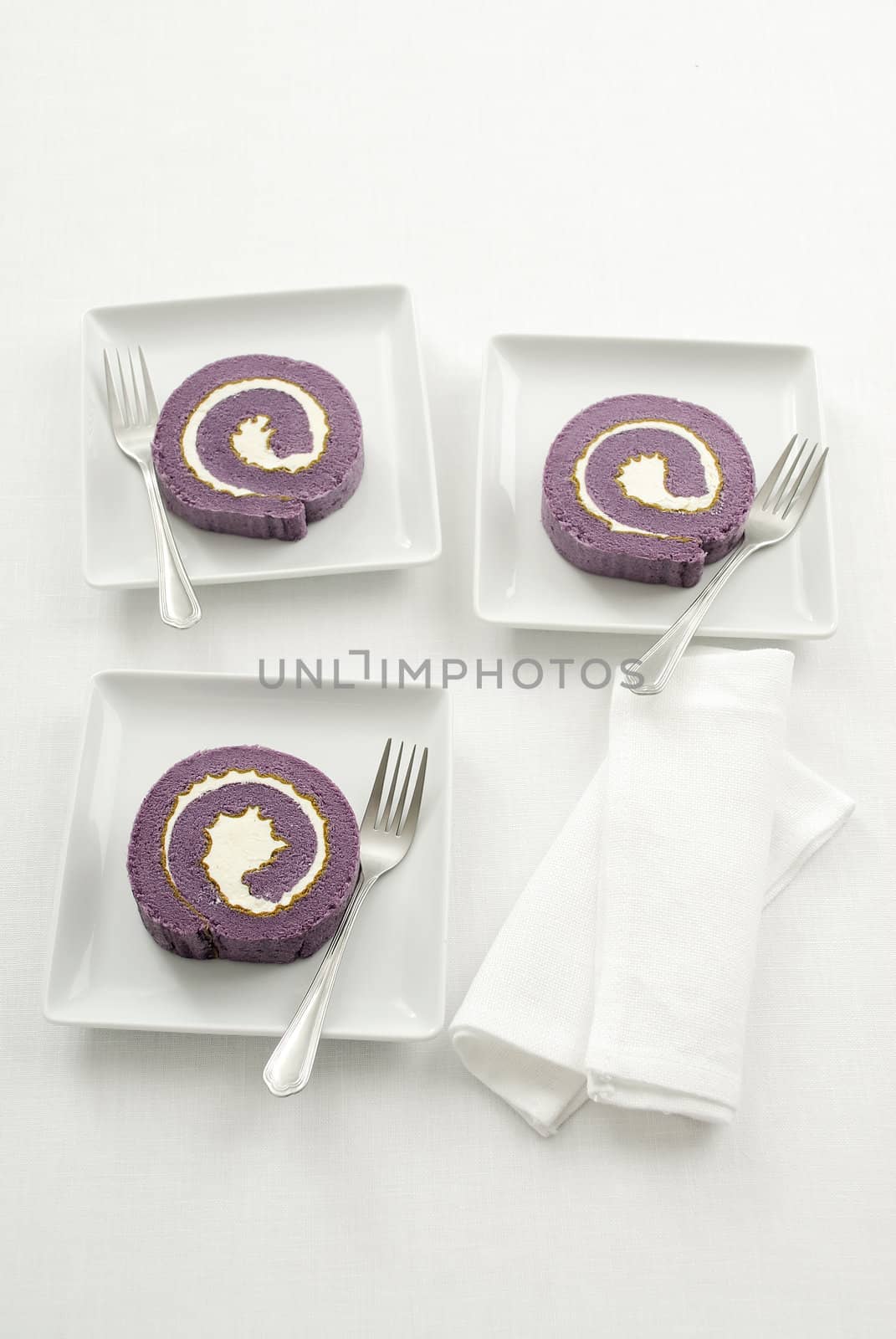 Blueberry roll cake on white plate