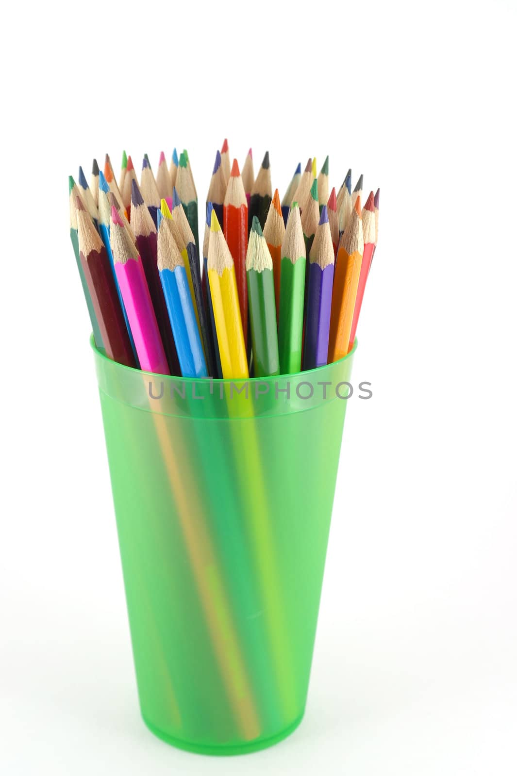 Color pencils in the green prop over white. Shallow DOF.