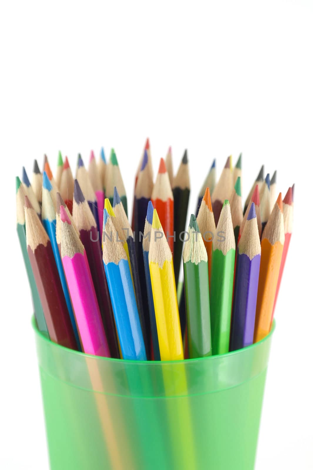 Color pencils in the green prop over white. Shallow DOF.