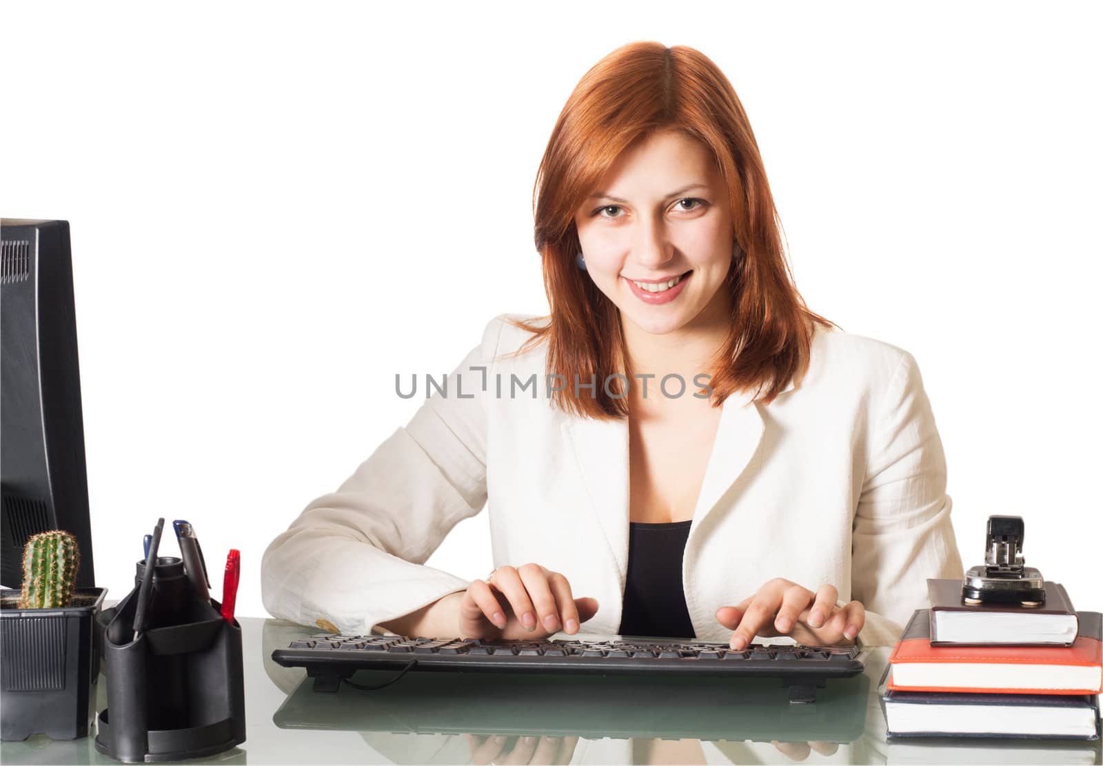 smiling girl typing on a computer keyboard in the office on a white background isolated
