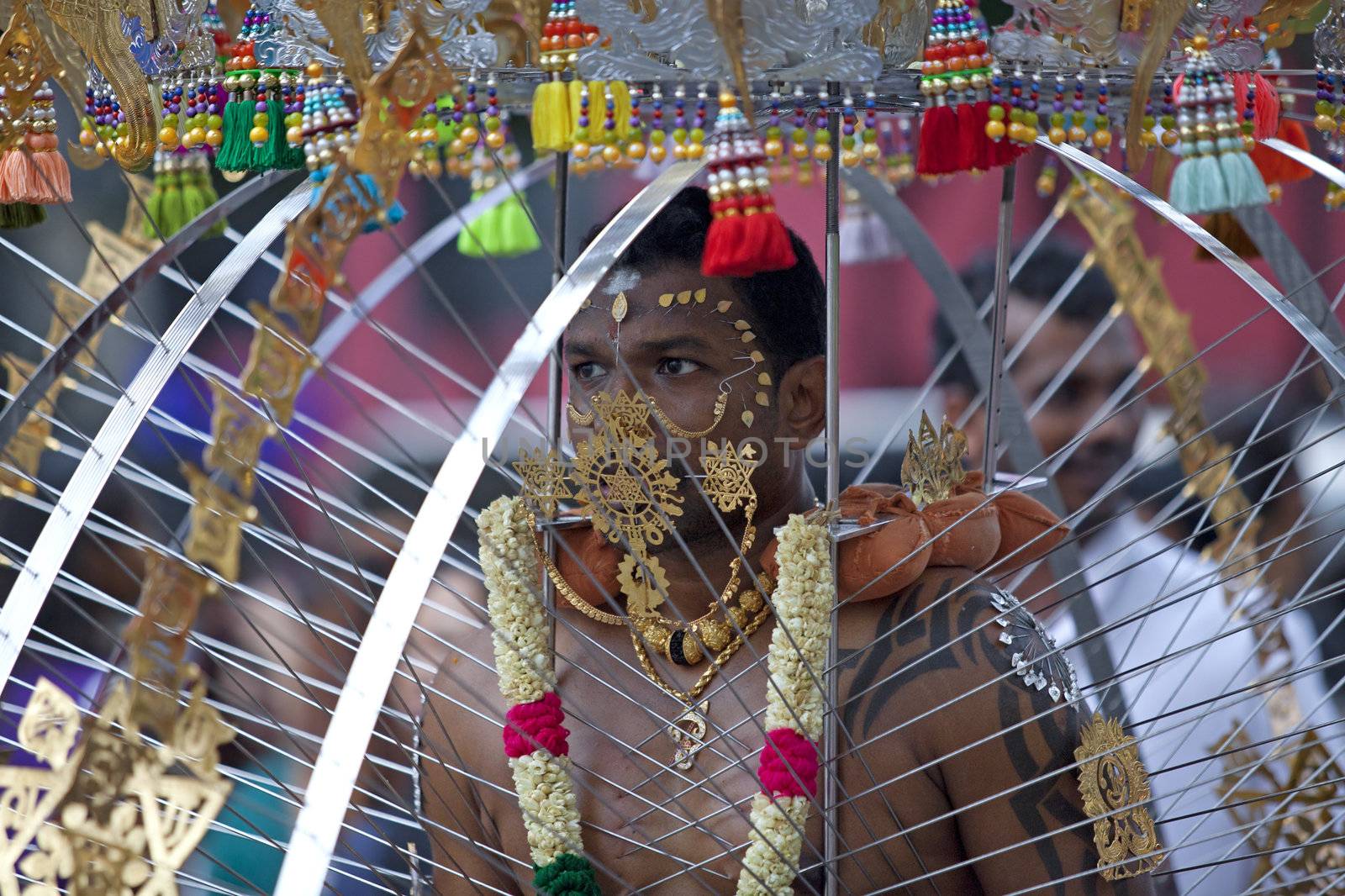 SINGAPORE - JANUARY 27: Male Hindu devotee carrying a kavadi at Thaipusam taken on January 27, 2013 in Singapore. Hindu festival to worship God Muruga.