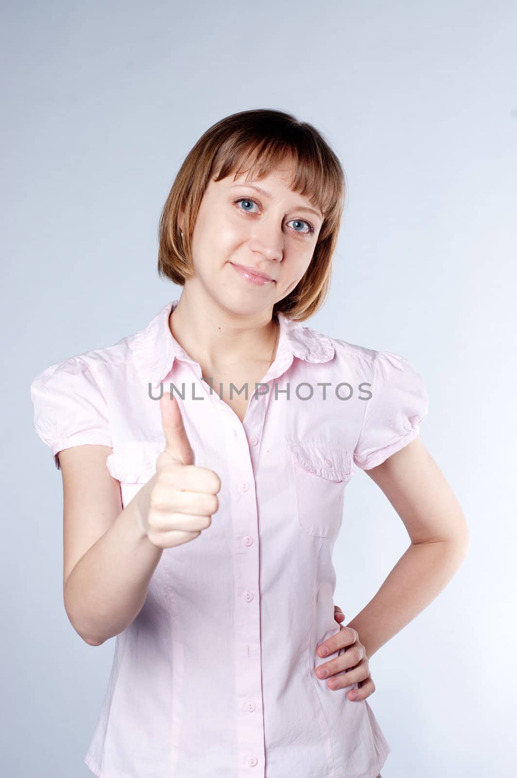 young girl with a raised thumb