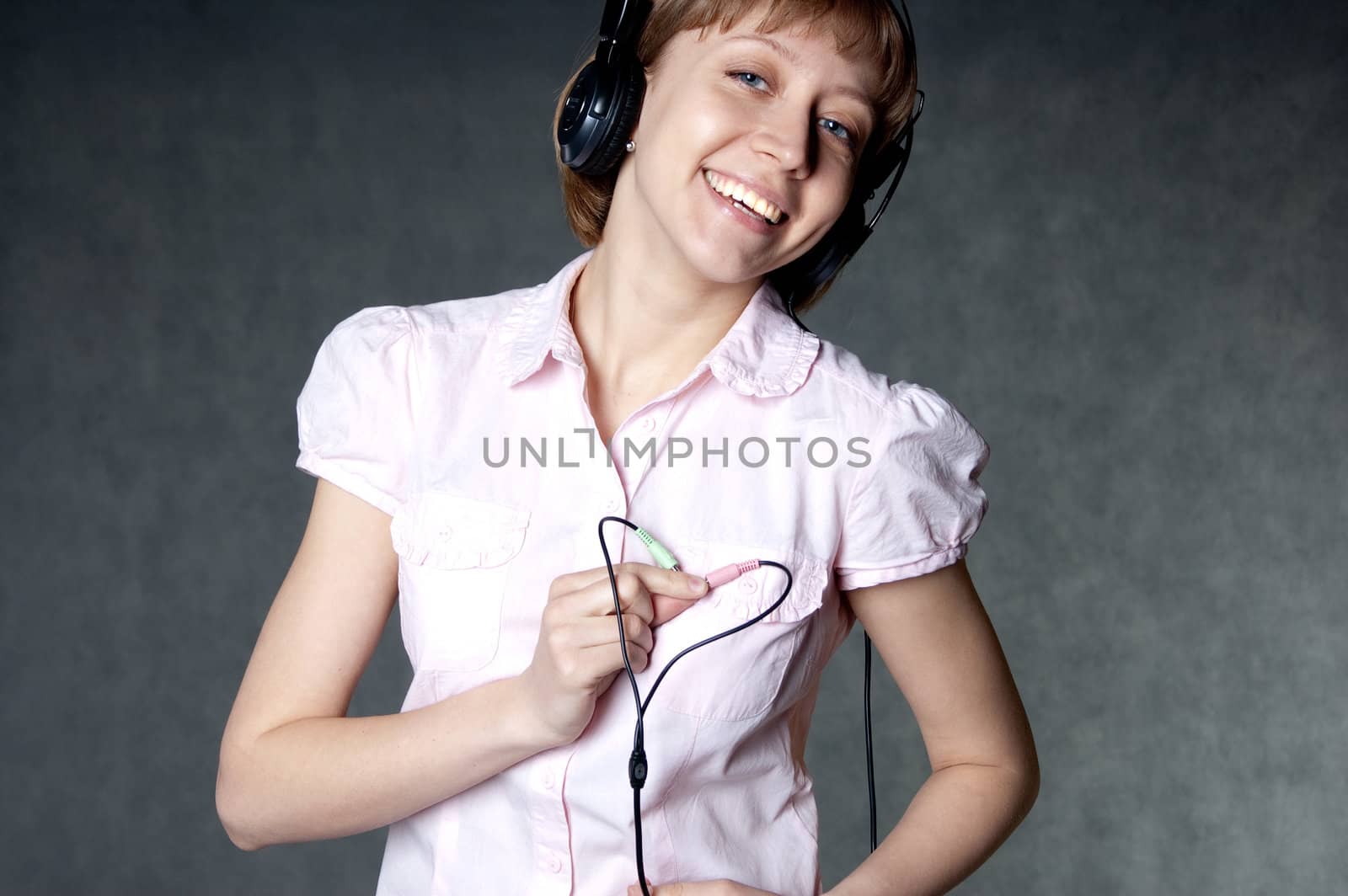 young girl with headphones holding two wires by Triphka