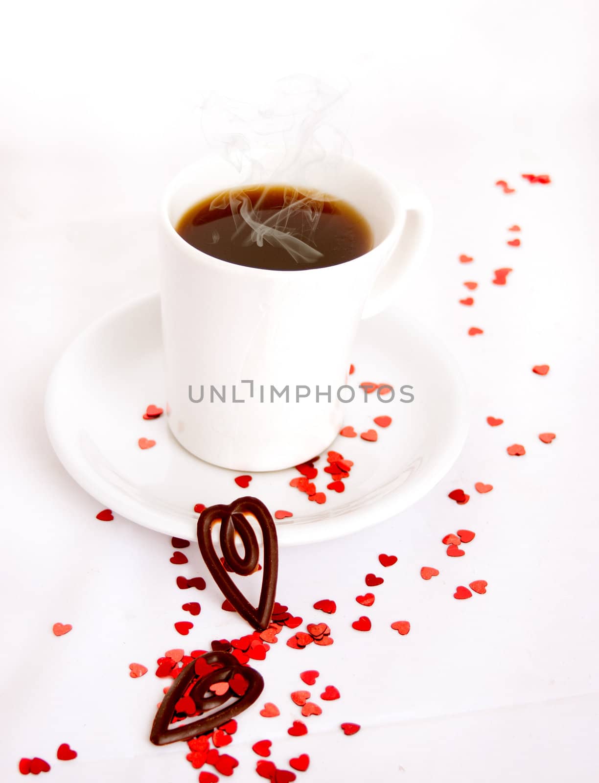 Coffee cup on a white background with red glitter hearts