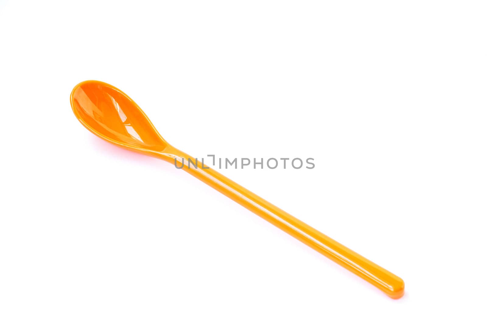 An orange plastic spoon on a white background