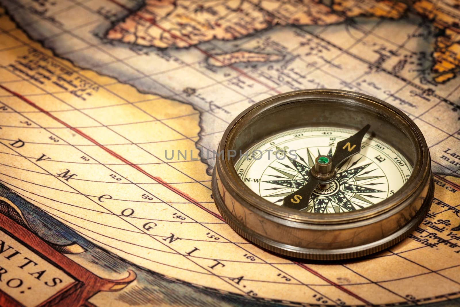 Old vintage retro compass on ancient map