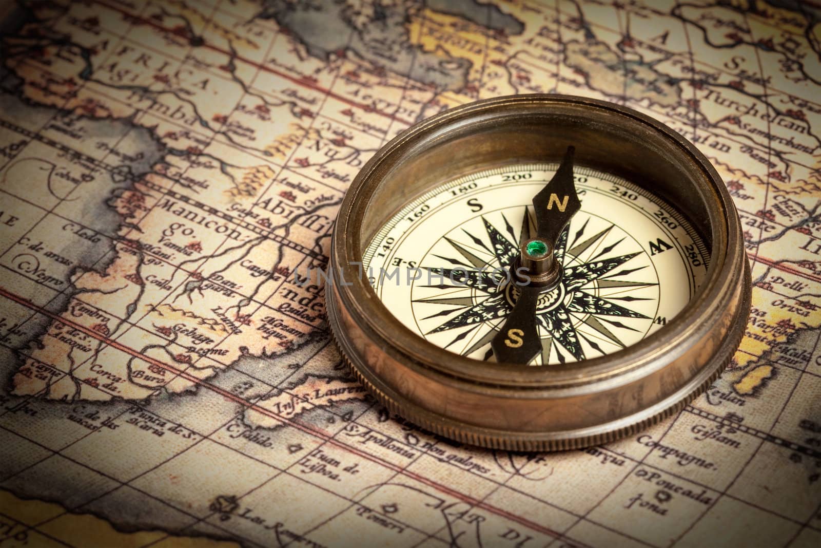 Old vintage compass on ancient map by dimol