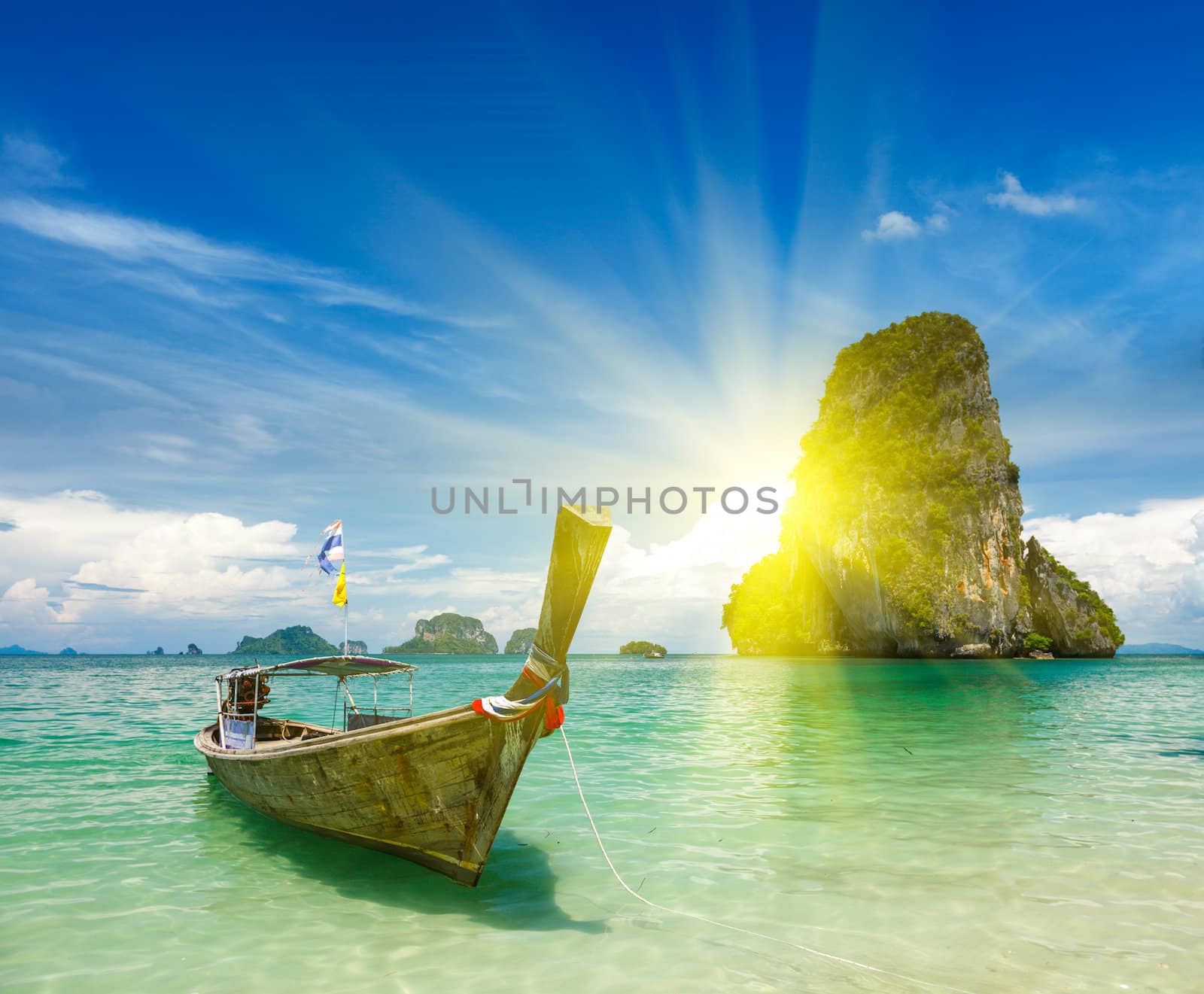 Long tail boat on tropical beach (Pranang beach) and rock, Krabi, Thailand