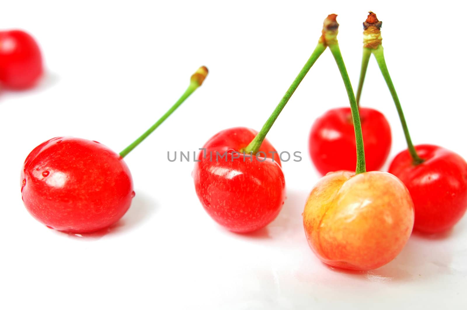 Red cherry fruits on a white background