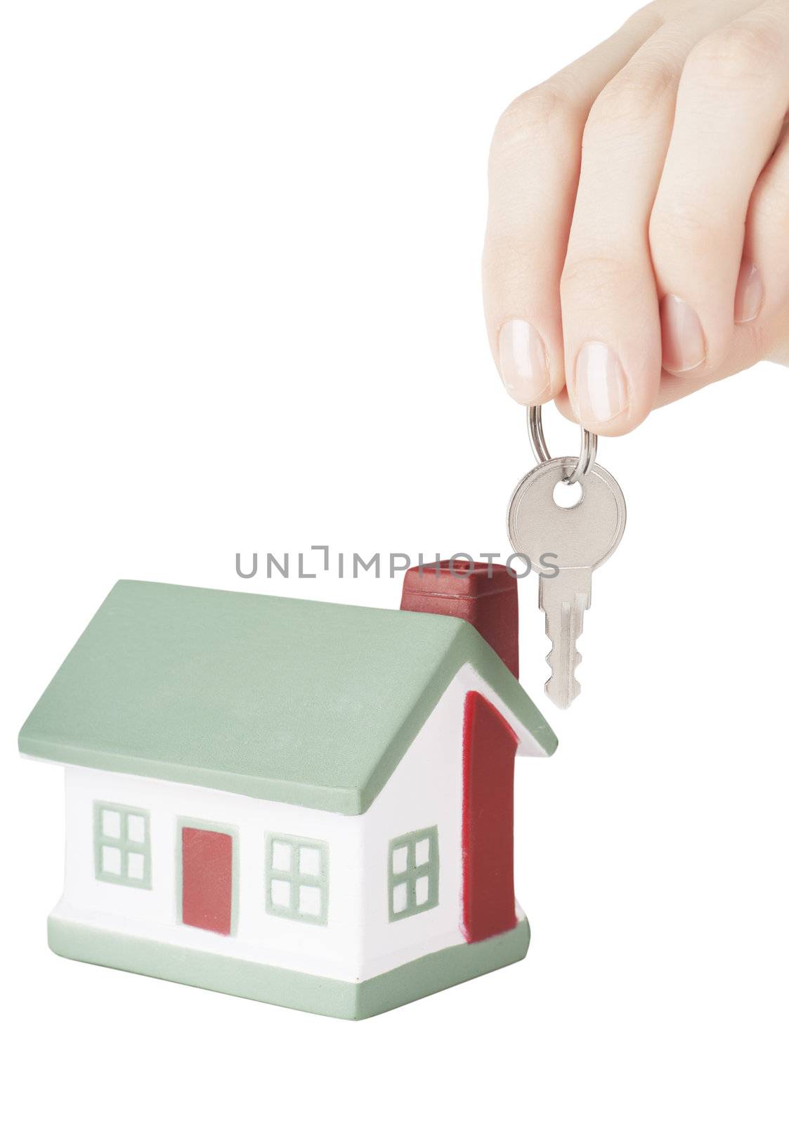 Little house toy and hand with key isolated over white background