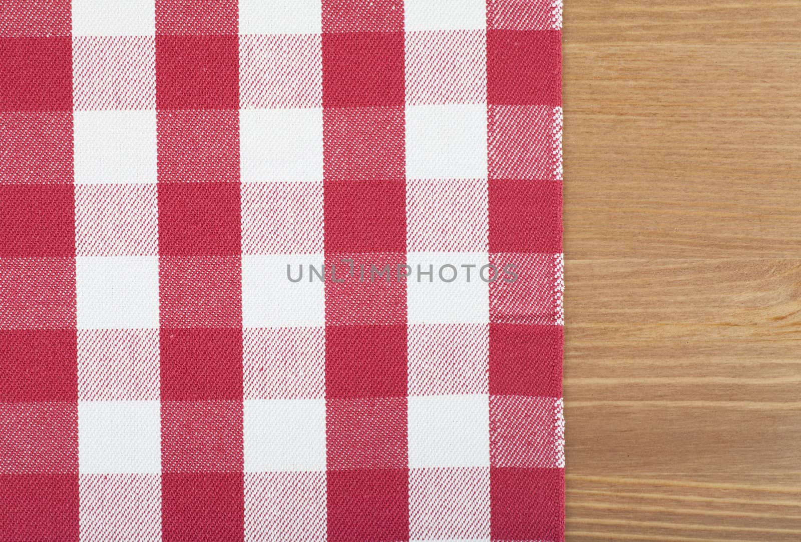 Checked with red and white tablecloth on a wooden table