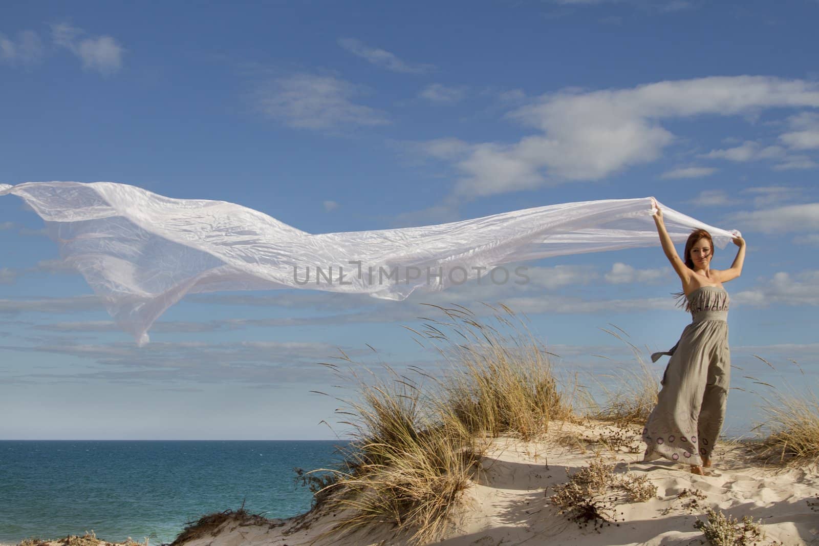 beautiful girl in the beach with long beautiful white cloth by membio