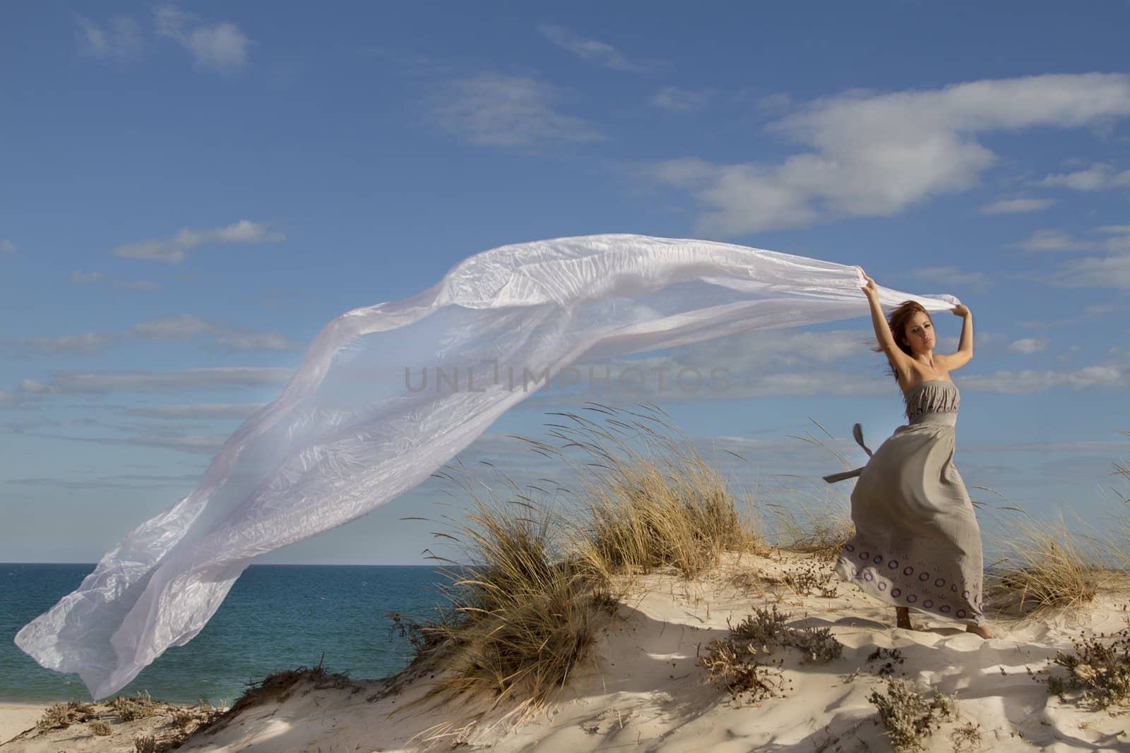beautiful girl in the beach with long beautiful white cloth by membio