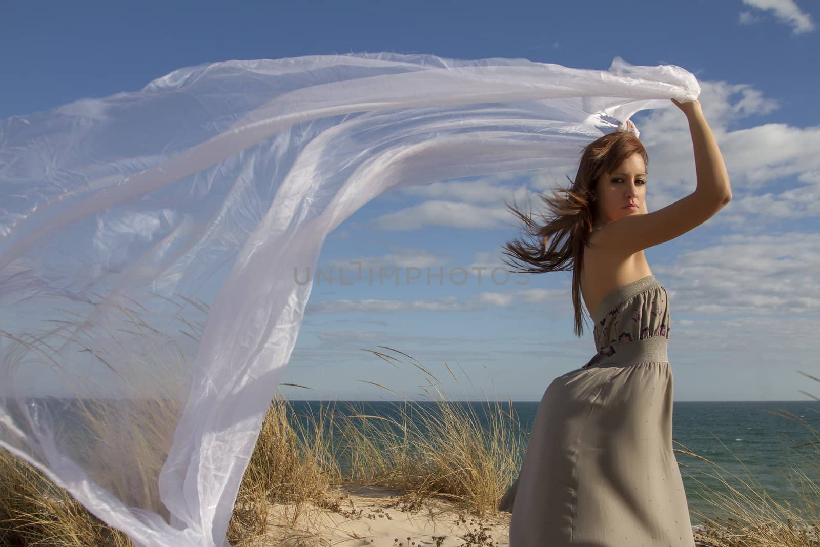 beautiful girl in the beach with long beautiful white cloth by membio