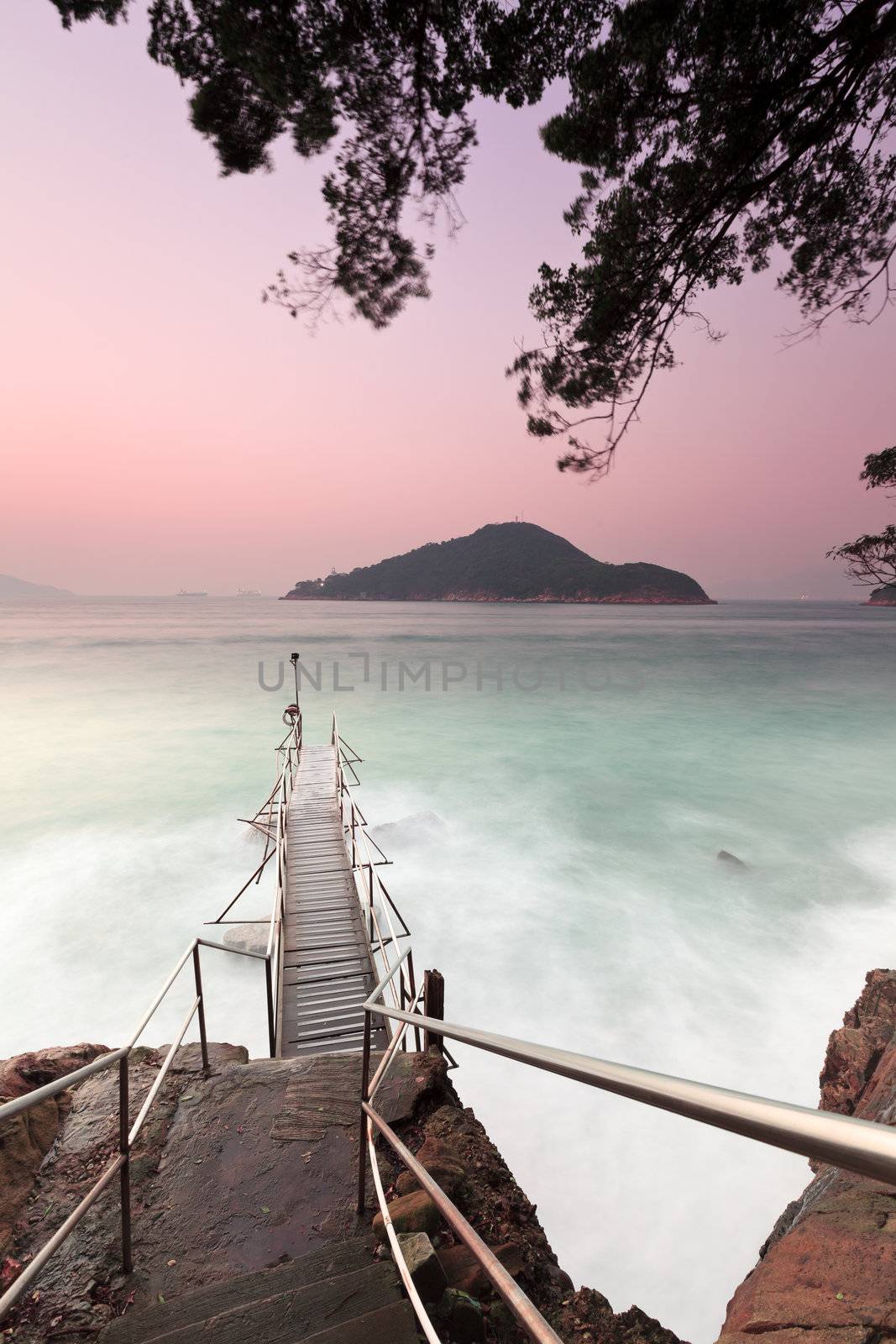 Sunset pier with strong wave motion