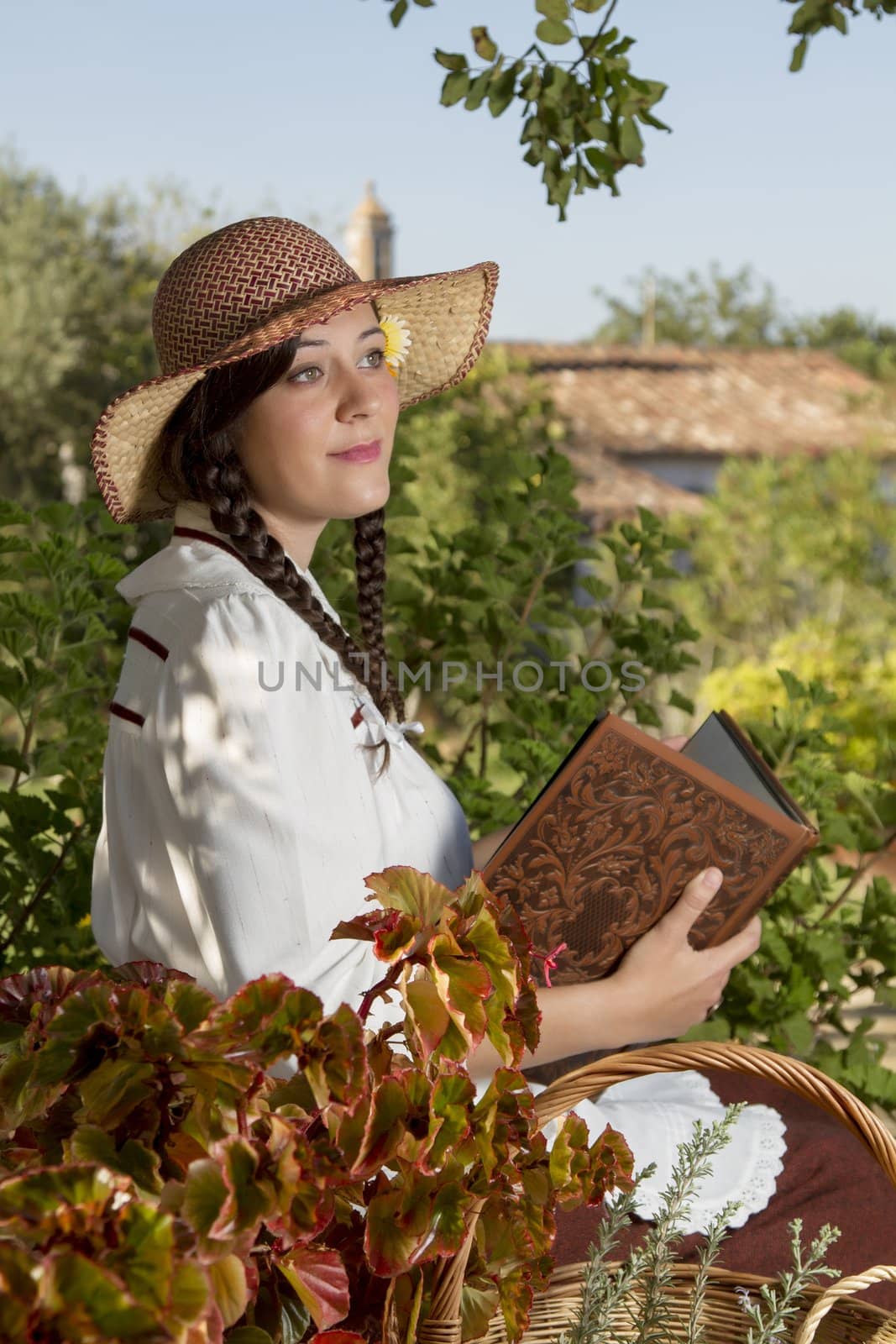 View of a beautiful girl in a classic dress reading a story book.
