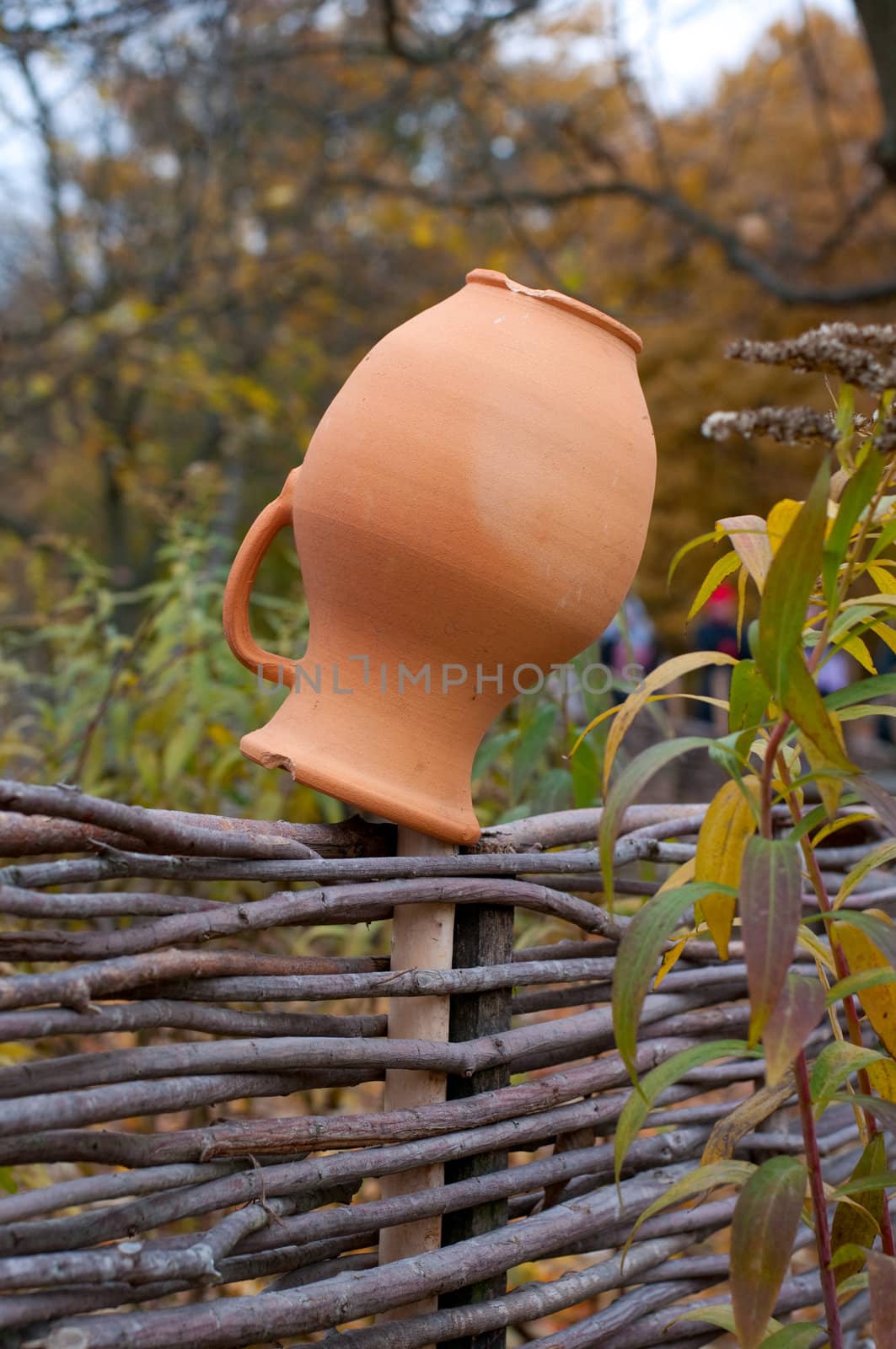 Clay jug on fence, a village tradition in Ukraine.