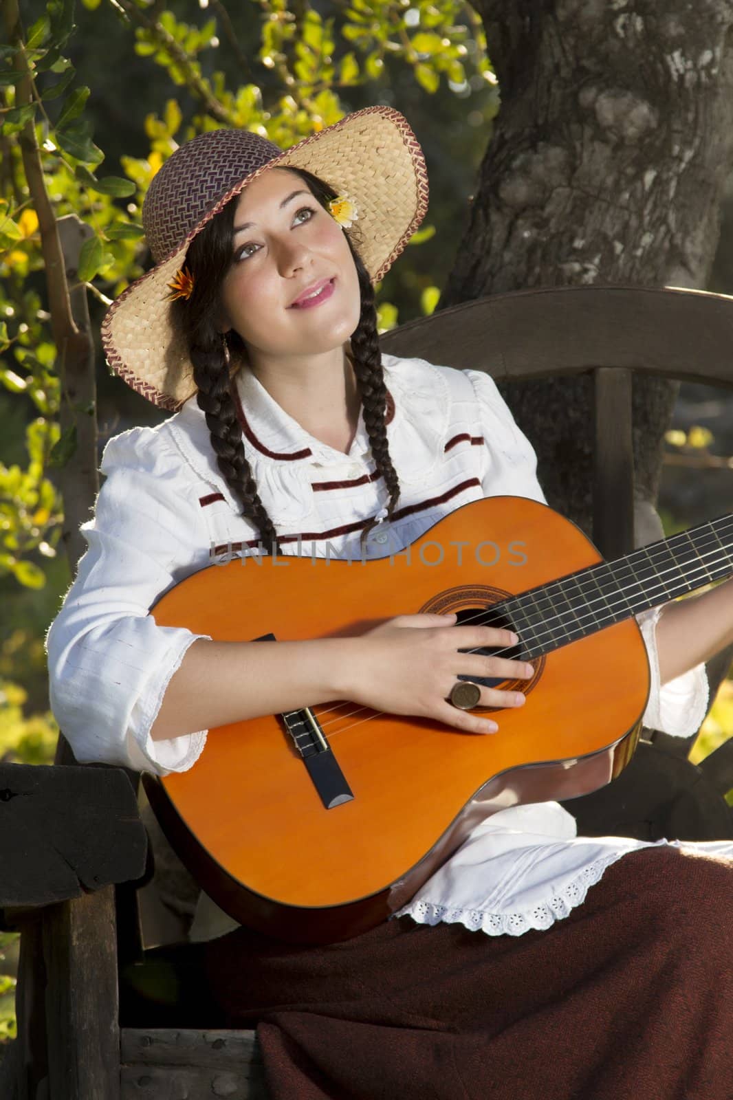 View of a beautiful girl in a classic dress in a countryside set.