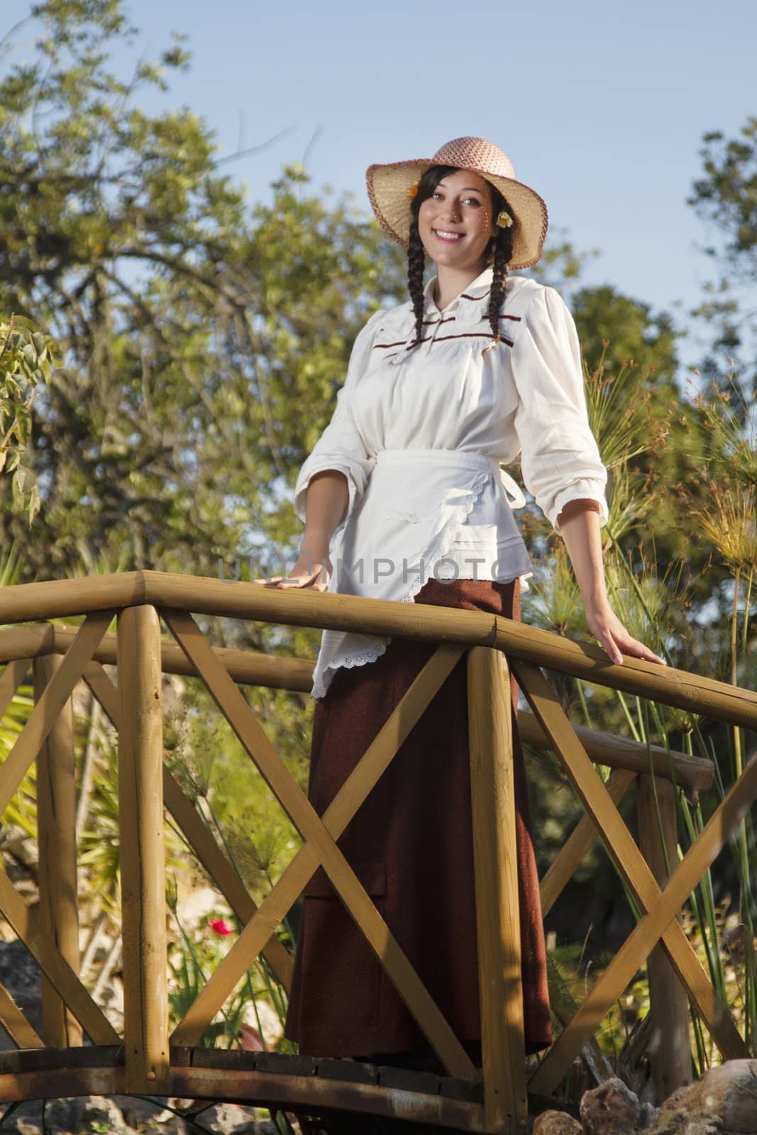 View of a beautiful girl in a classic dress in a countryside set.