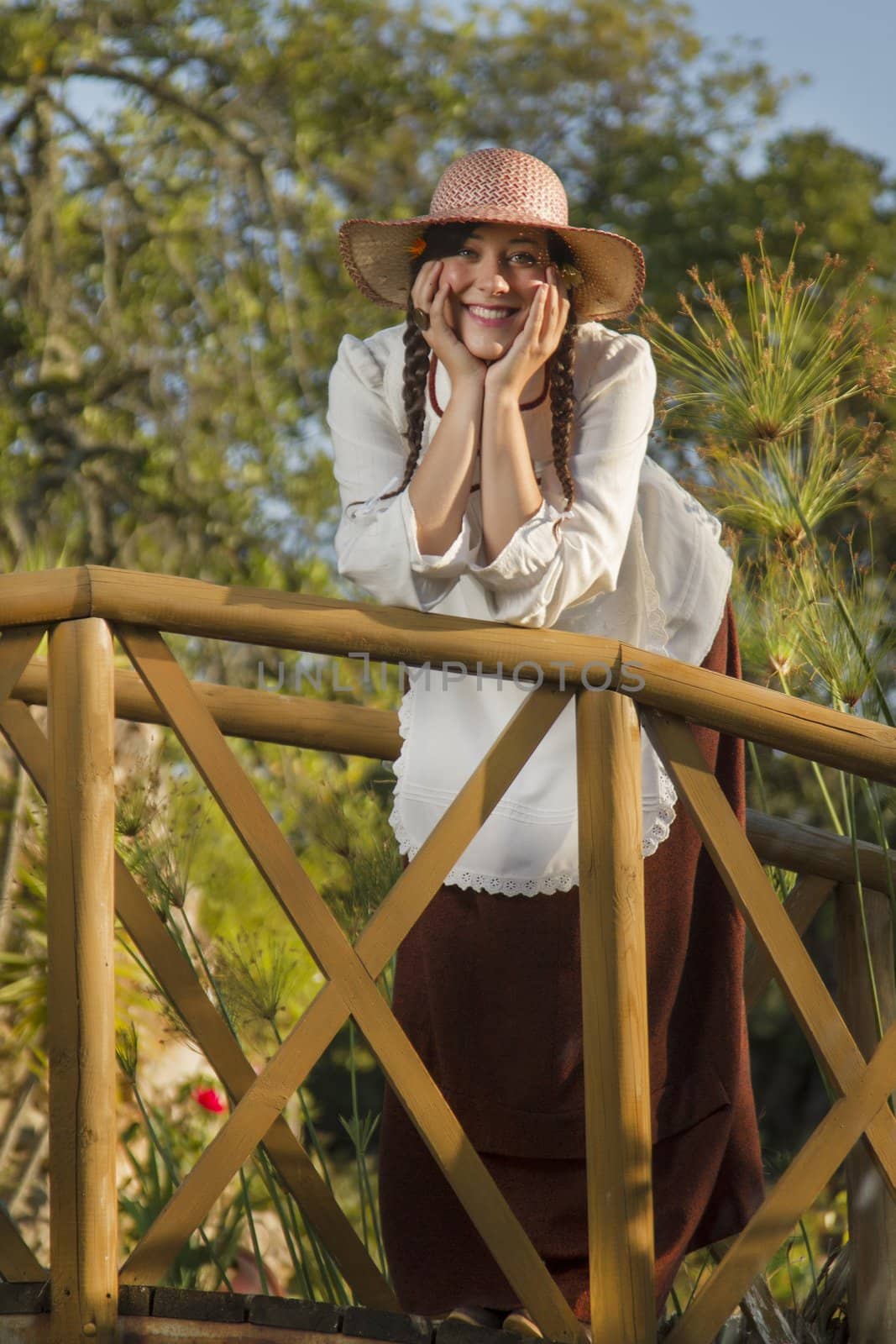 View of a beautiful girl in a classic dress in a countryside set.