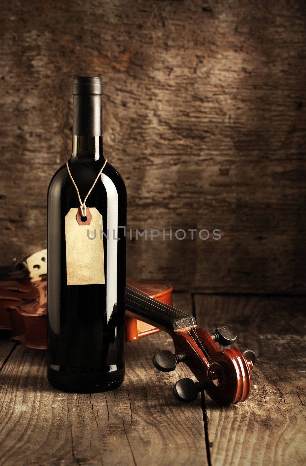 Red wine bottle and violin by stokkete