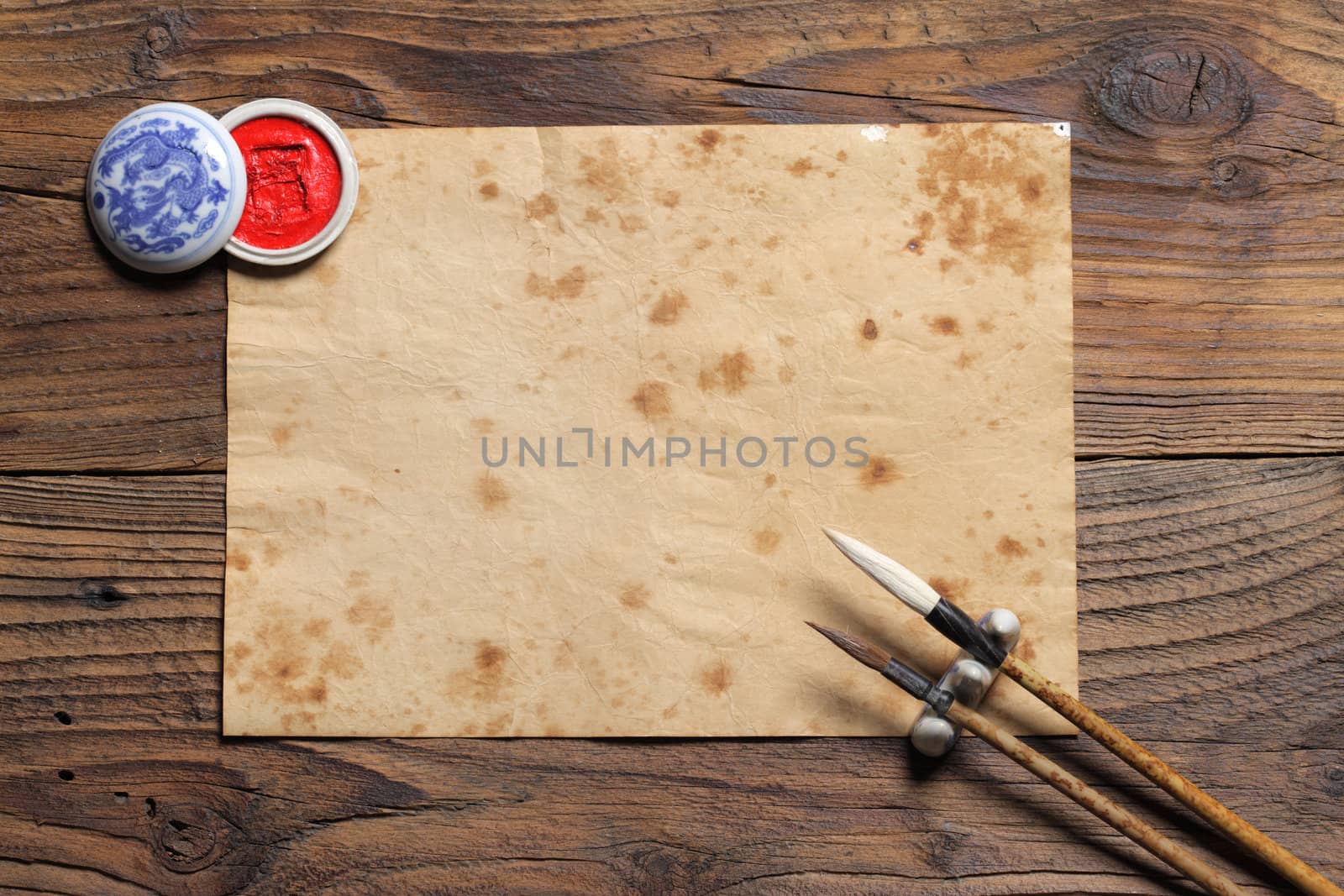 chinese brushes on wooden board, antique paper is a space for your text