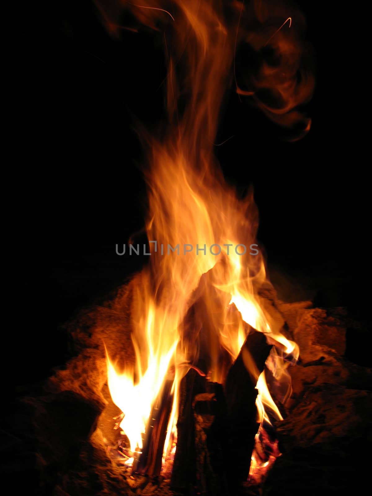 Closeup of burning red fire wood on black background by DNKSTUDIO