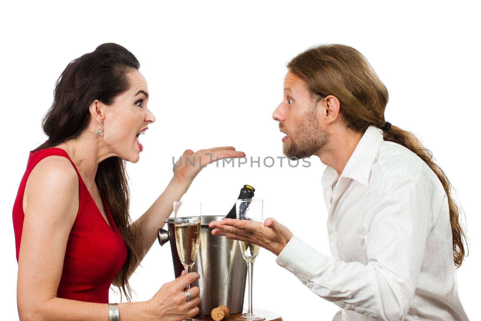 A couple arguing over a glass of Champagne on their Valentine's day date. Isolated on white.