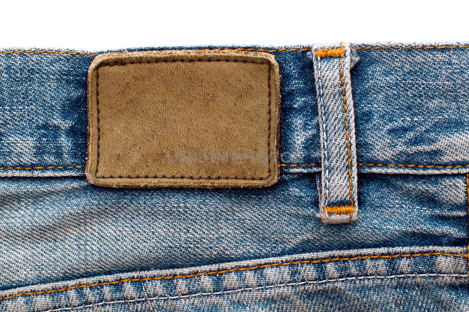 Blank leather jeans label sewed on a blue jeans
