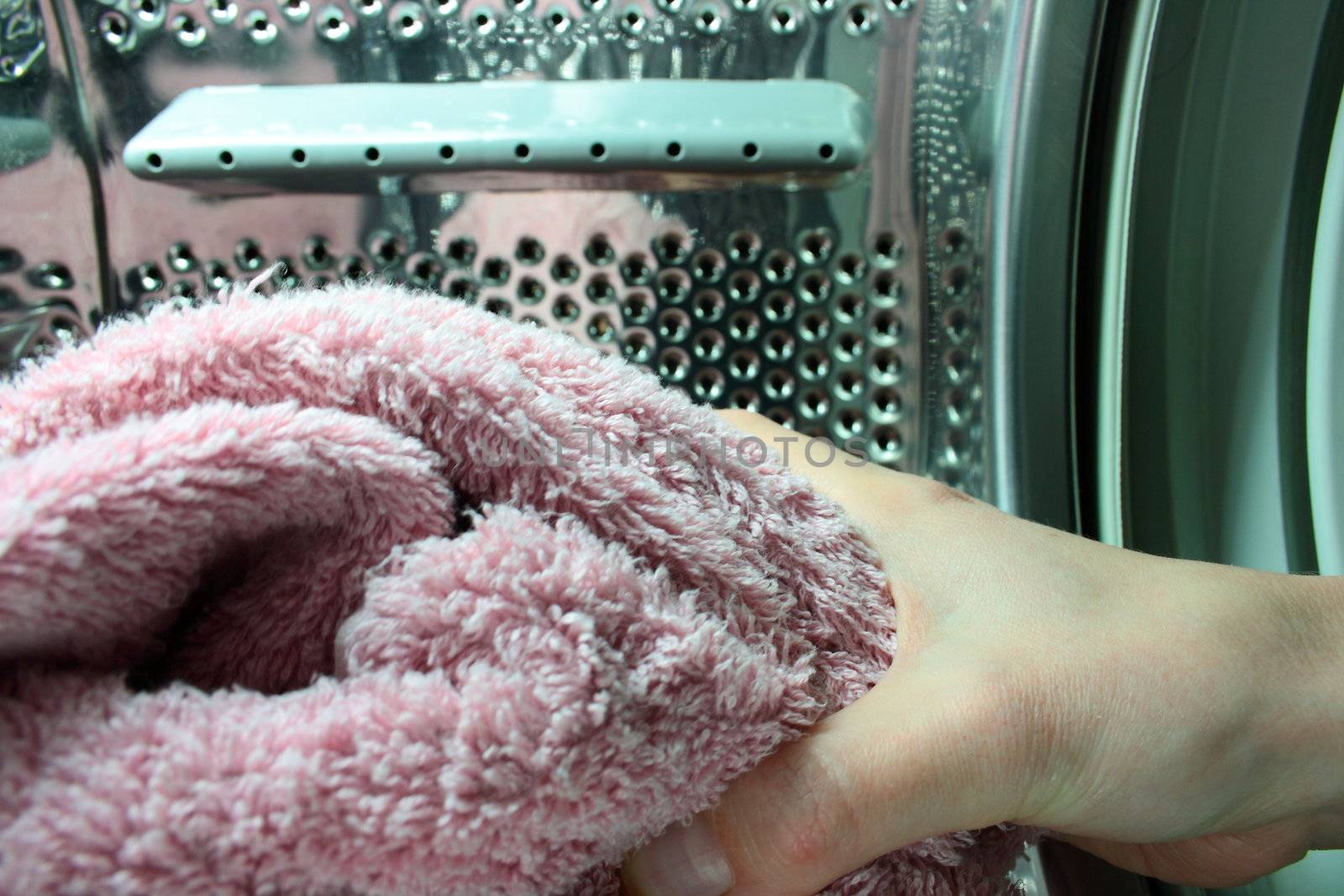 inside of washing machine hang holding towel