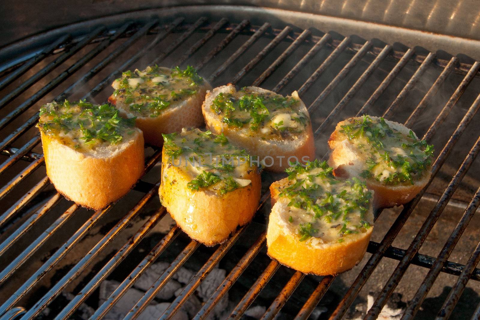 Garlic Breads on a Barbecue by Kartouchken