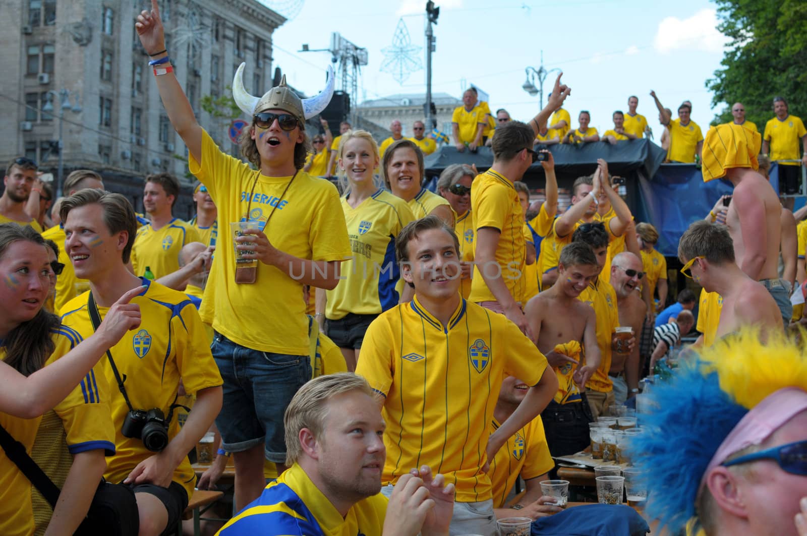 KIEV, UKRAINE - JUNE 19: Swedish football fans relax in the official fan zone of EURO-2012 in the center of Kiev, June 2012. EURO 2012 is a European football championship held by UEFA.