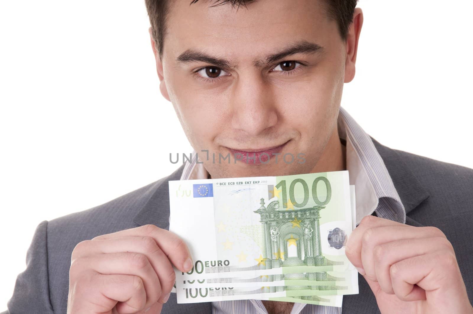 smiling young man showing 100 euro bills isolated on white background